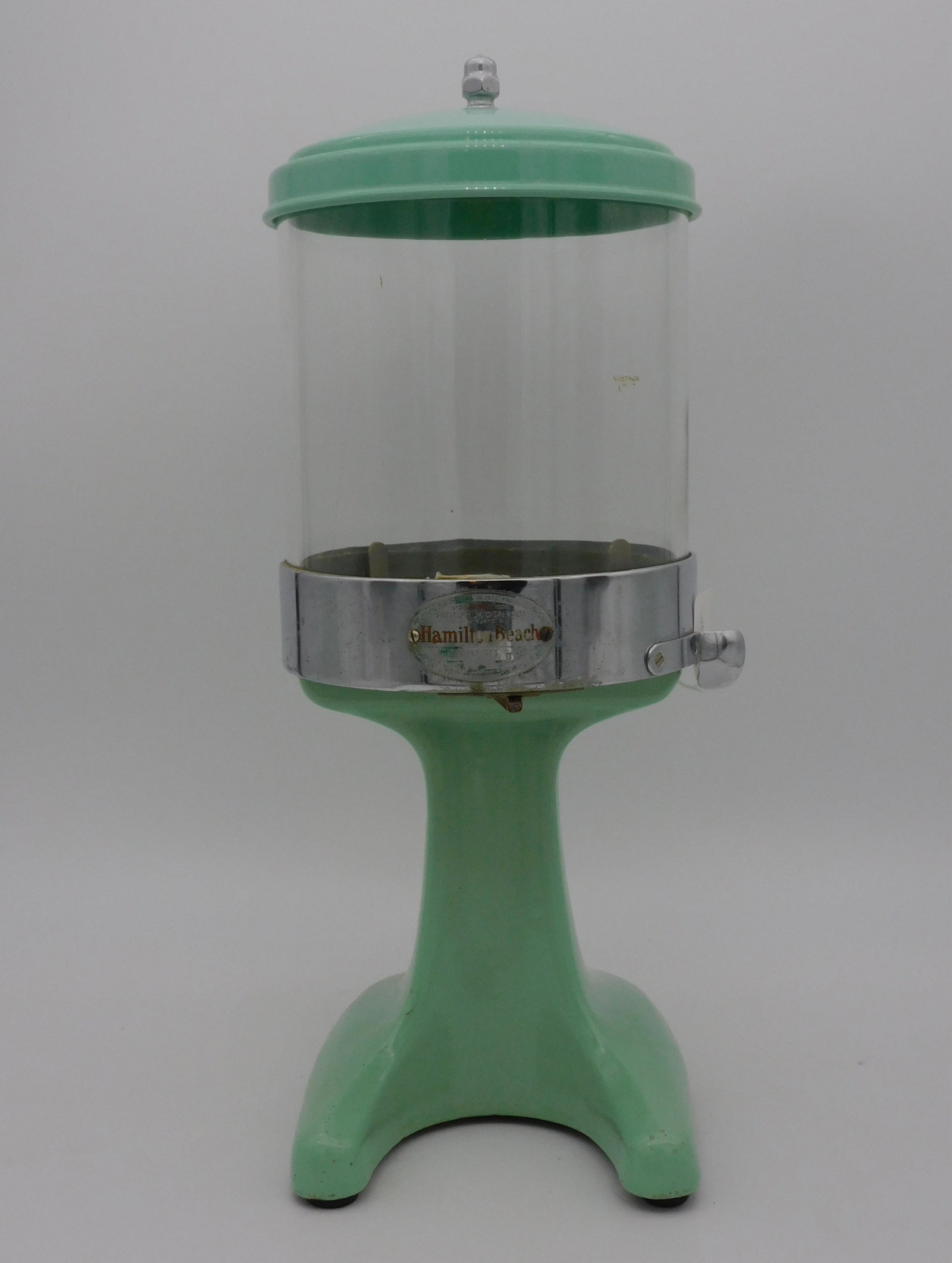 Hamilton Beach green enameled Malt Dispenser. 18": high, approx. 7 1/2" diameter. Good overall condition.