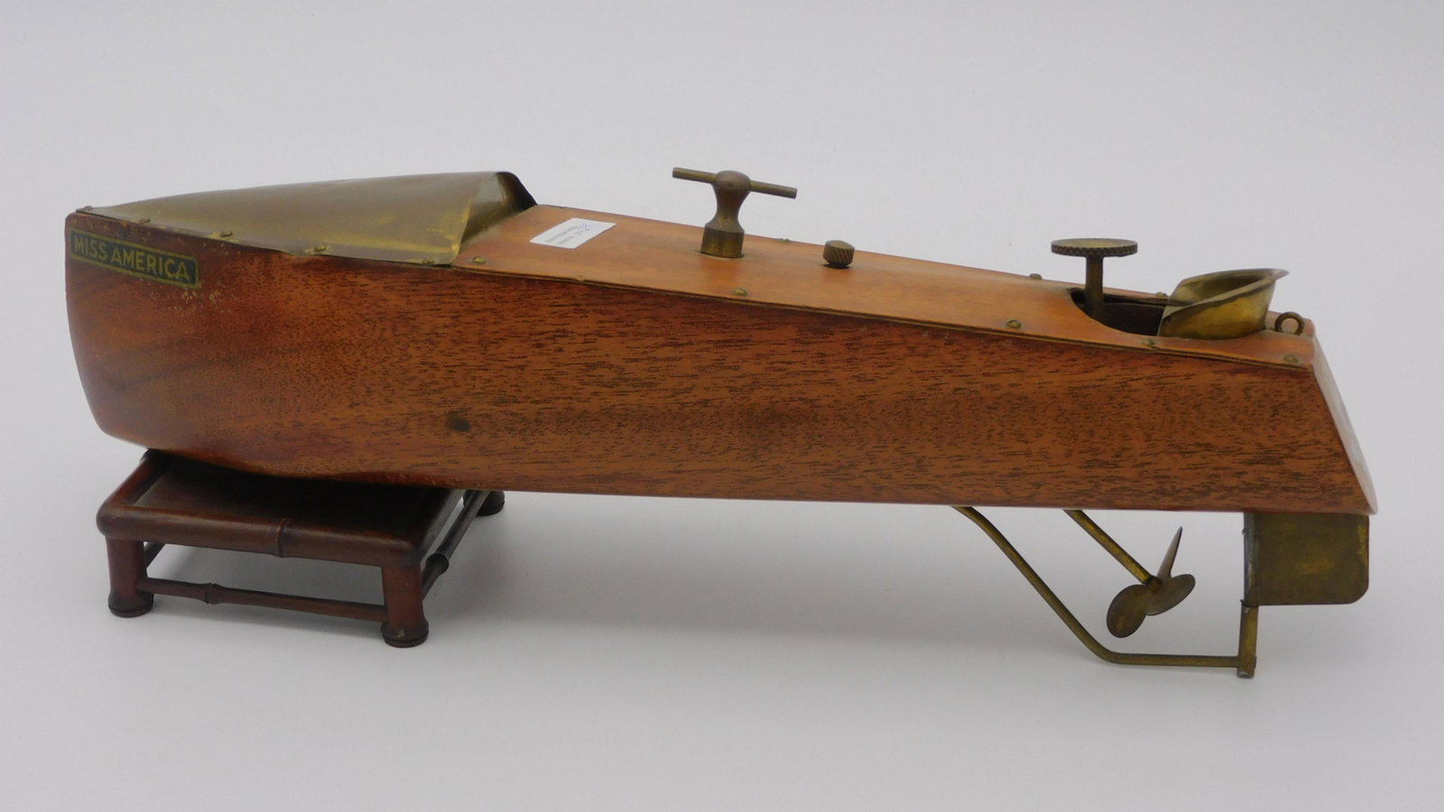 Vintage Mengel Playthings "Miss America" Wind Up: wooden speed boat model. Brass and mahogany, original decals, working condition. 14" long, 3 1/2" wide. Overall very good condition, currently appears to be working.