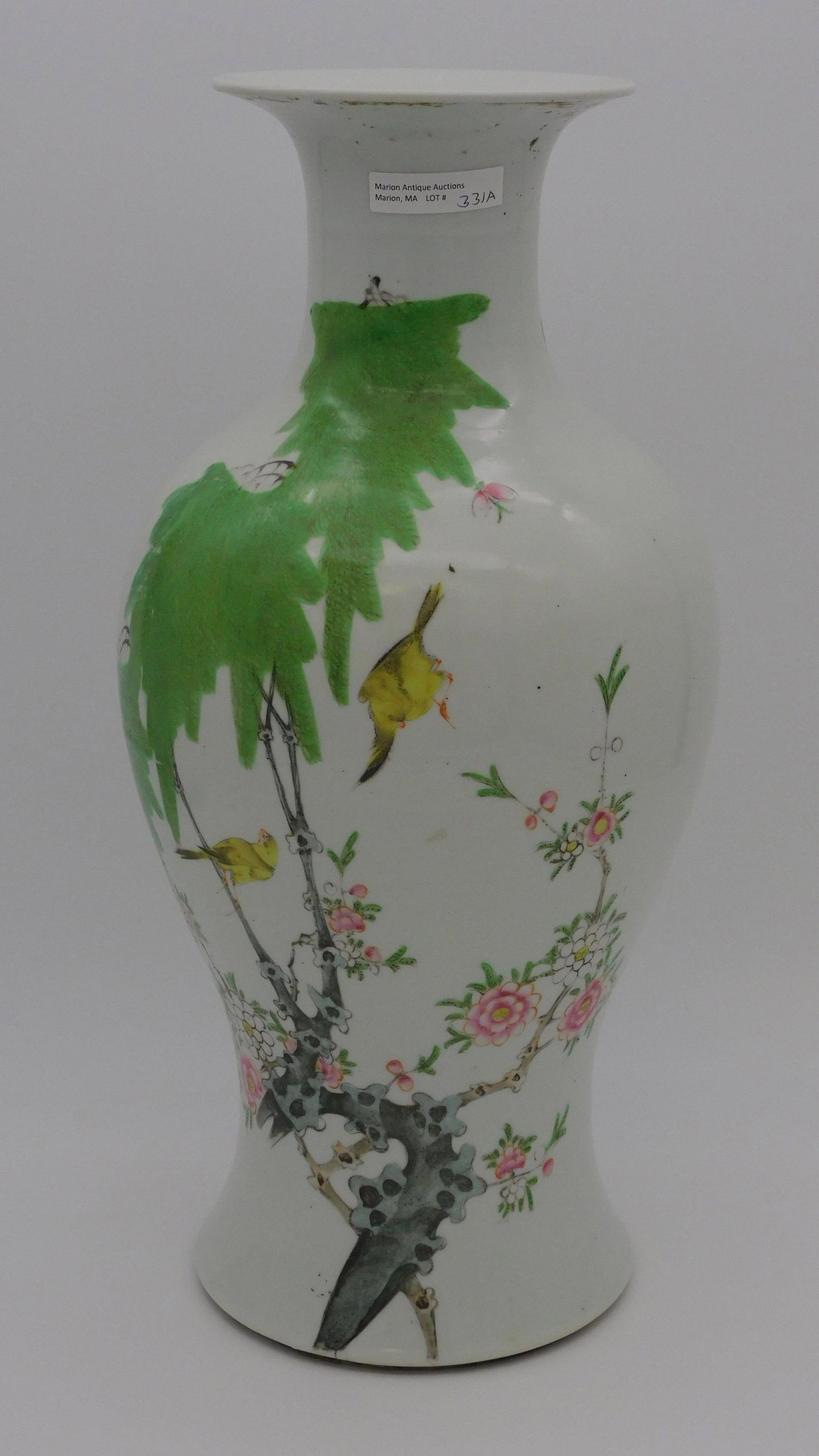 Chinese porcelain vase, 19th c. Depicts a: graceful plum tree with birds. Small butterflies painted around the opposite side. 17" high, 9" at widest diameter. Residue of old adhesive on underside of rim. Otherwise very good condition.