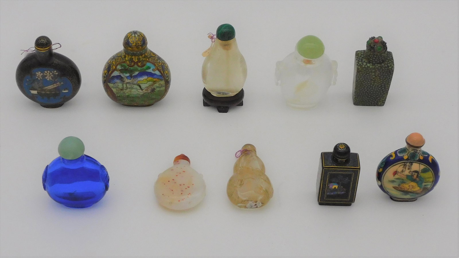 (10) miscellaneous snuff bottles, cloisonne,: glass, rock crystal, Peking glass, etc. Ranging in height from 2 1/8" to 2 7/8",
