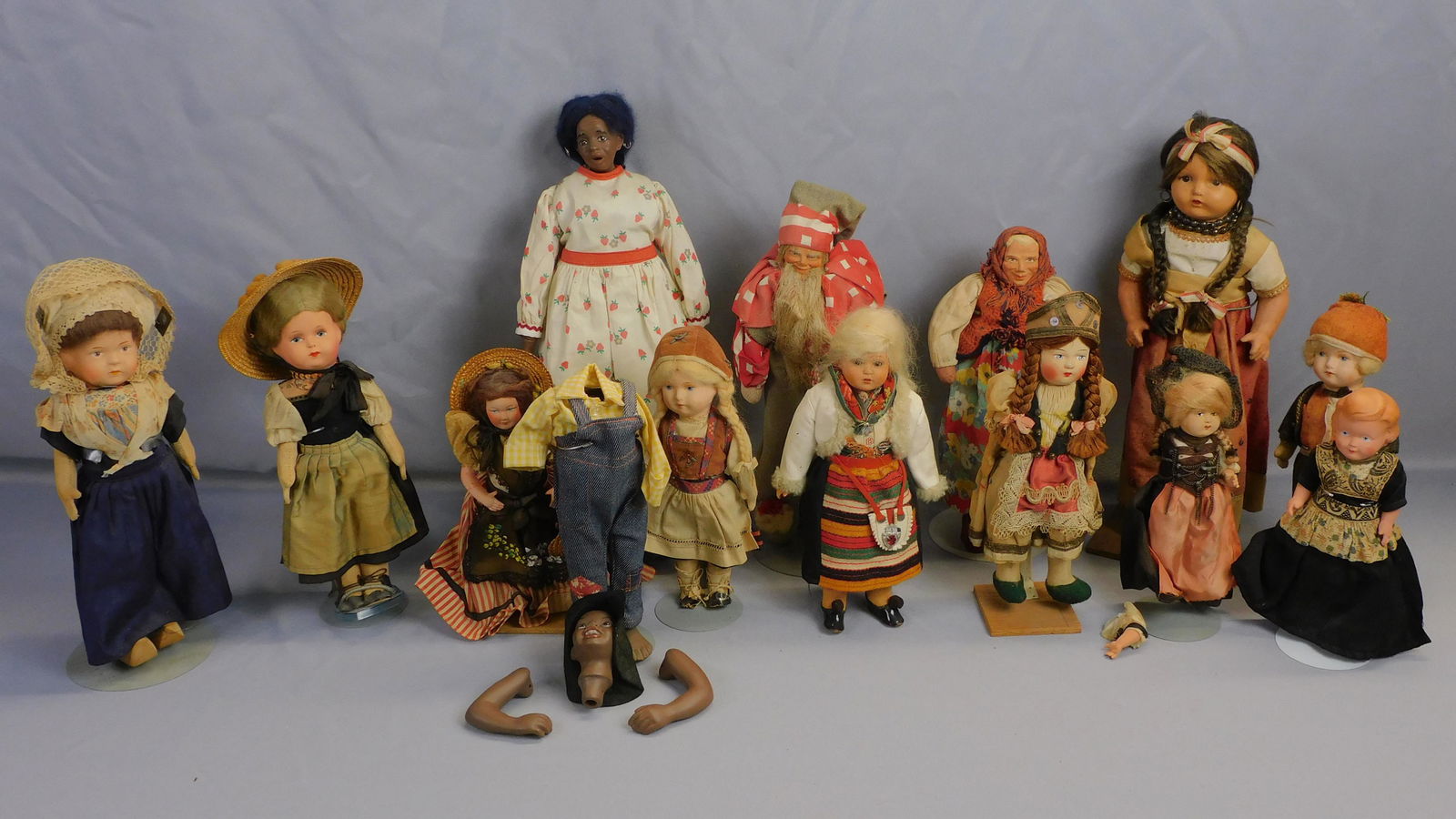 Collection of (14) composition, bisque, and cloth: dolls dressed largely in ethnic European costume. Ranging in height from 9" x 16 1/2" high. In as-found condition, showing wear consistent with age and use. The Sunny South doll is un-strung.