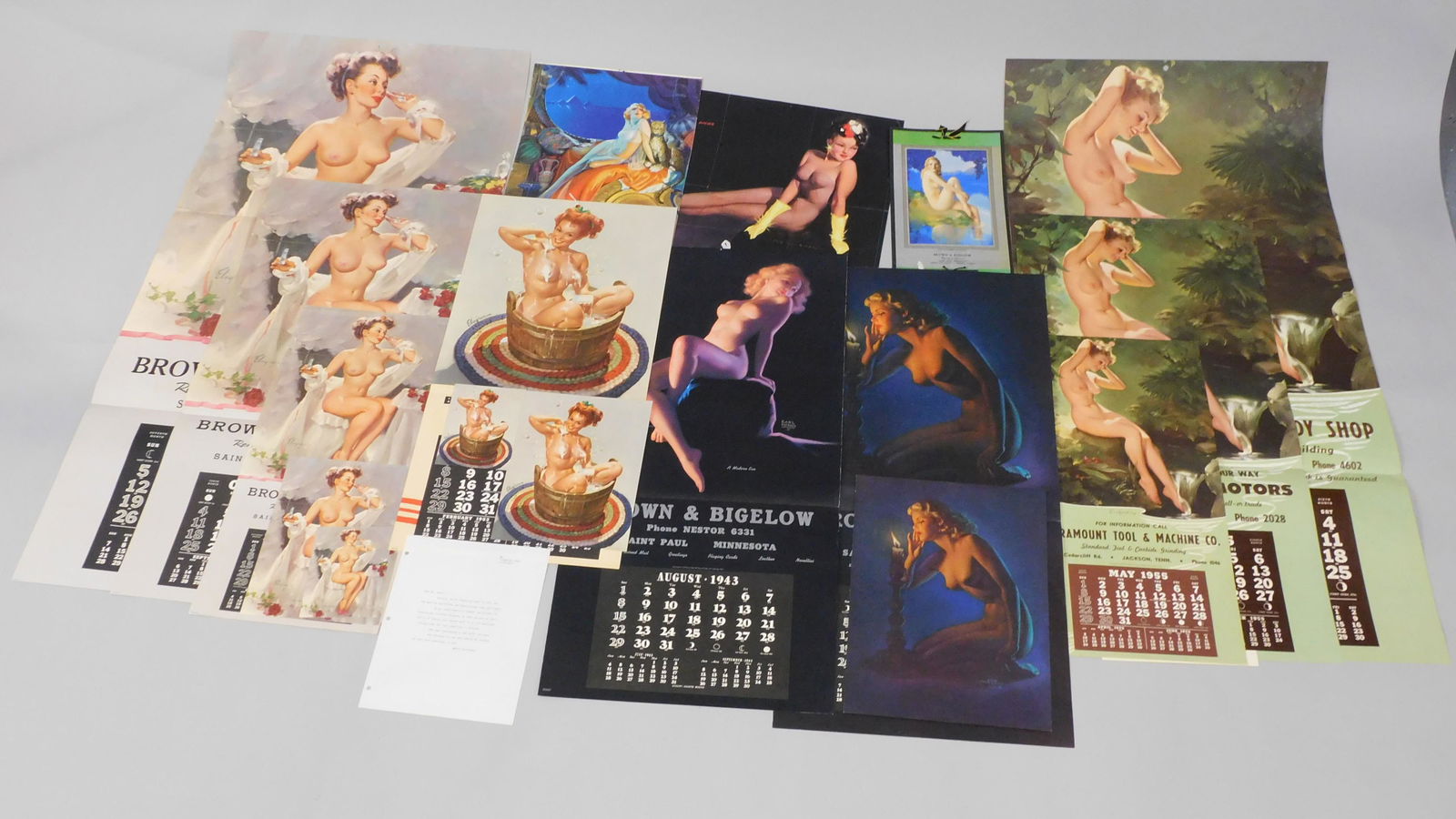 (17) Nude pin-up calendars and posters, ca.: 1920-50. Many by Brown and Bigelow. To include: a July 1953 calendar, very large, depicting a woman smelling a perfume bottle, 45 1/2" x 22", almost mint, unused condition. There are two other smaller