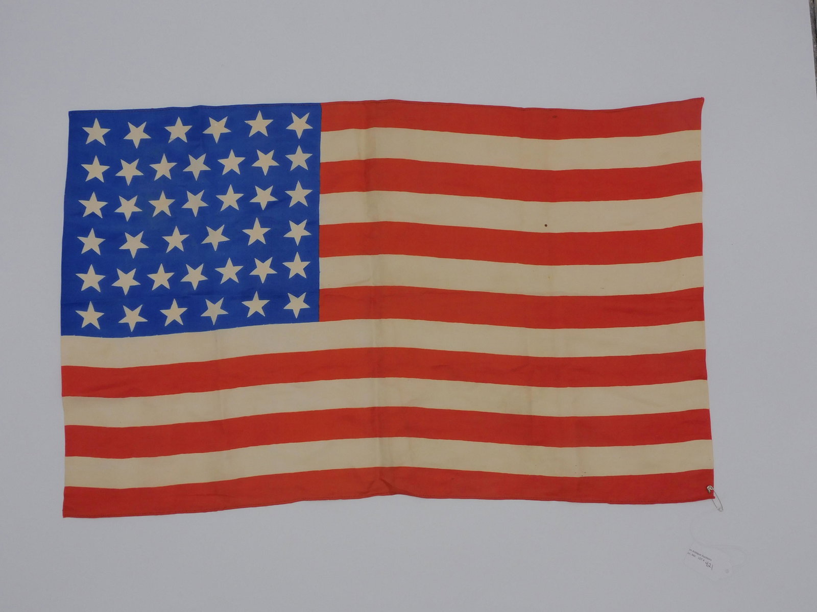 (39) Star American 6-7-7-6-7-6 pattern parade: flag. Silk, ca. 1889. The unofficial American flag for North Dakota's (inc. November 2, 1889) entry into the Union. 24 1/4" x 15". Extremely good condition, no tears. Very bright colors, a few tiny sp