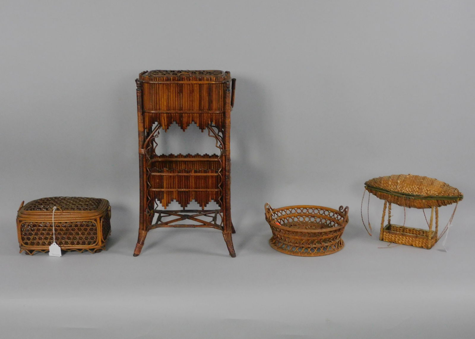(4) Victorian sewing baskets, to include: 1): swing handle with star caned lid, Japonisme design, bears original Wakefield Rattan Co label, ca. 1880, original natural finish, 26" high, 13" wide, 10" deep, star caned top is slightly depressed, min