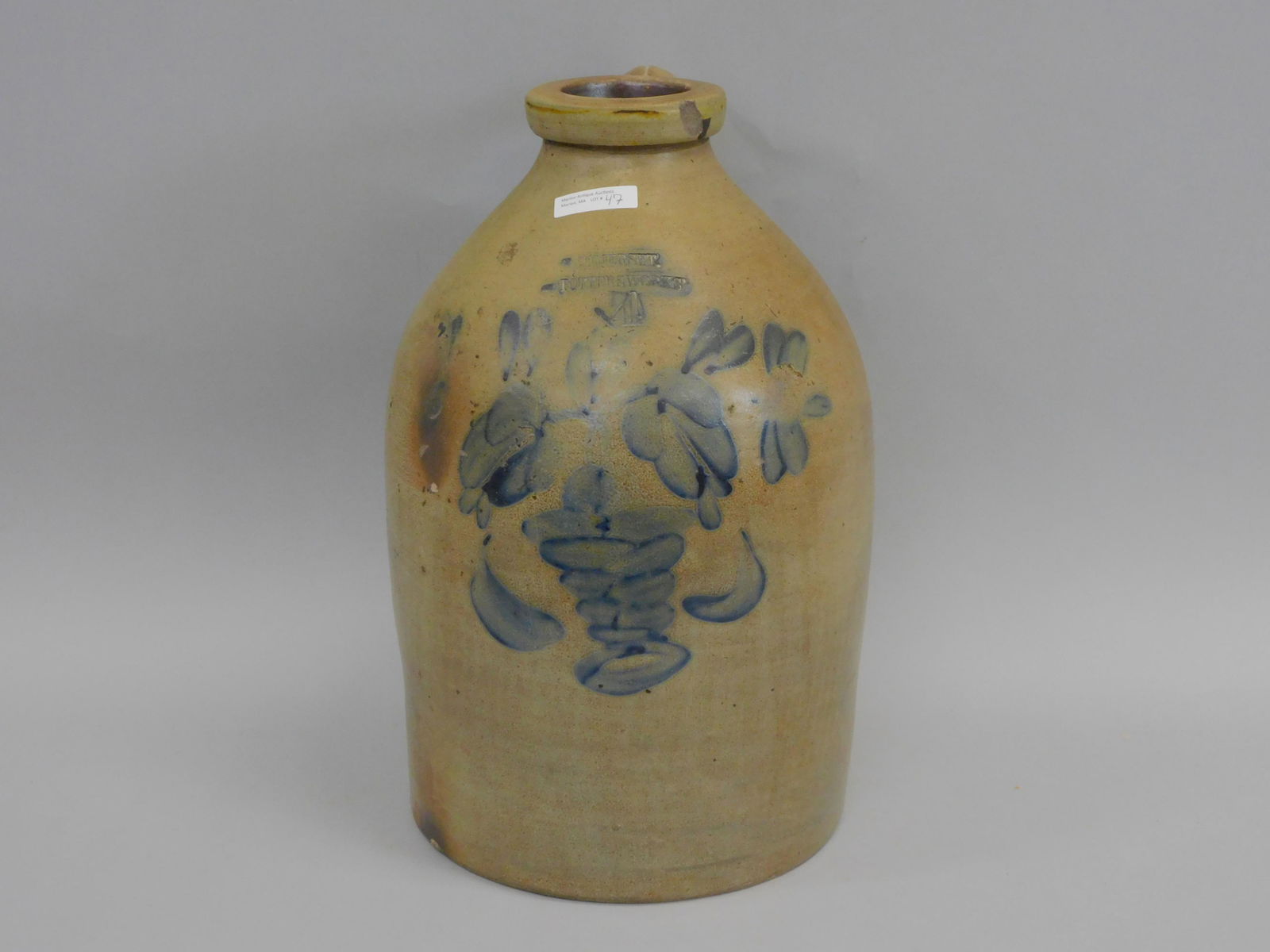 Somerset Potter's Works. Mid 19th century.: Somerset Massachusetts. 4-gallon stoneware jug with handle. Blue decorated with potted flower design. 16 1/2" high x 9 3/4" diameter. Chip to the lip
