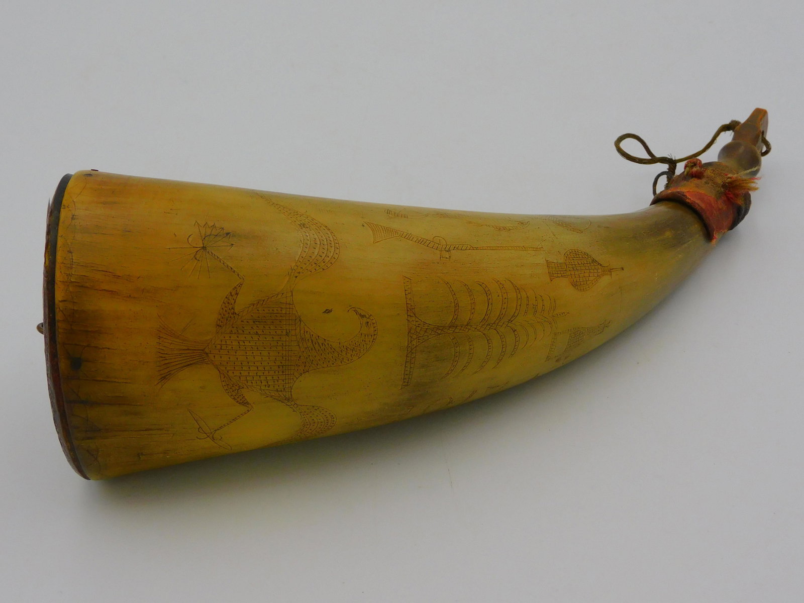 American engraved powder horn. Dated 1817.: Engraved powder horn with images of an eagle, a powder horn, musket, tree, goblet, decanter, snake, initials, bellows, and other. Primitive folk art. 8 1/2" long. Good original condition.