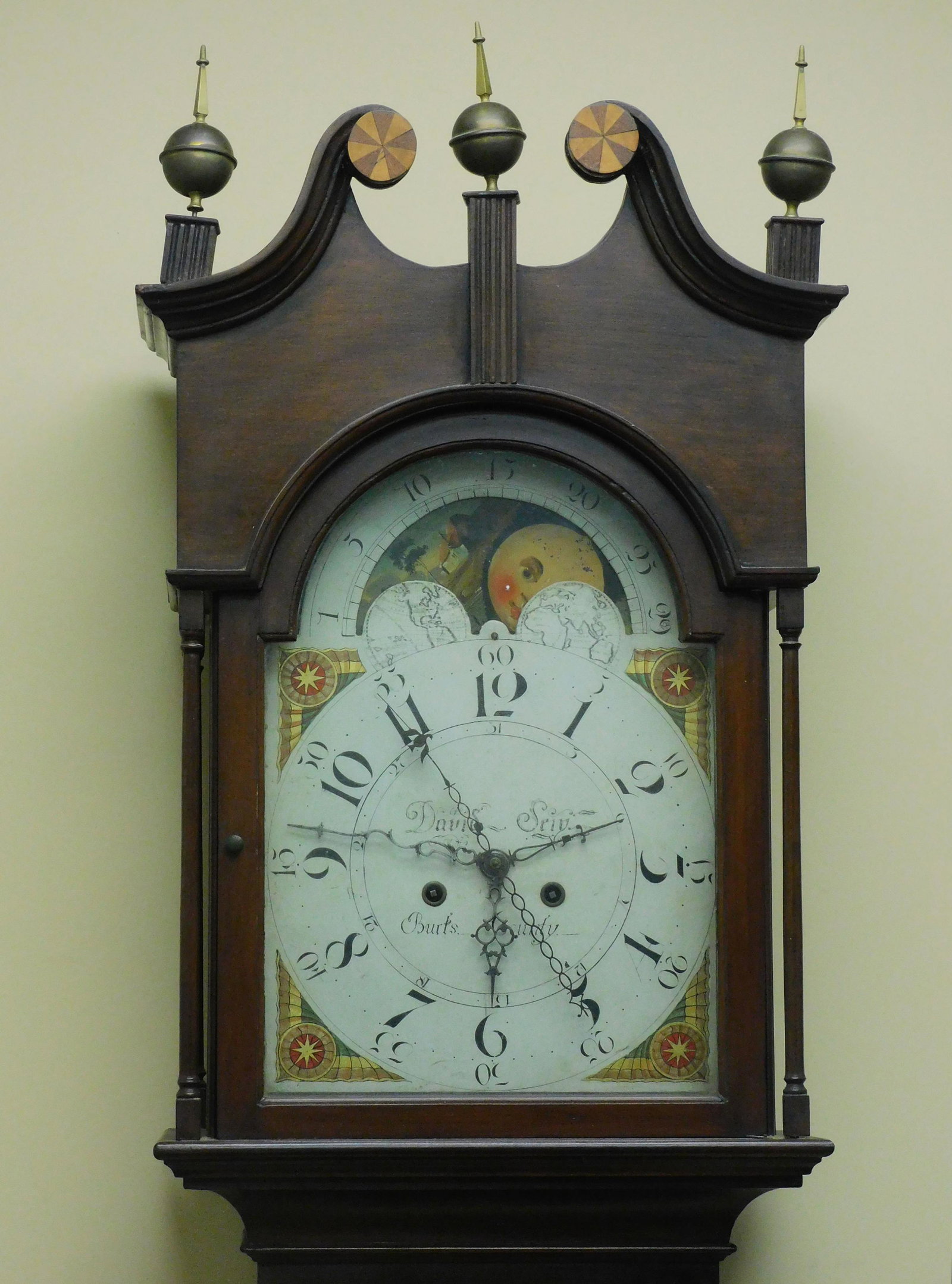 Pennsylvania tall case clock by David Seip.: Early 19th century. Cherry case with original finish, three original brass finials dovetail bonnet and an inlaid pinwheel swan neck top. A tombstone door flanked by slender columns with original glass