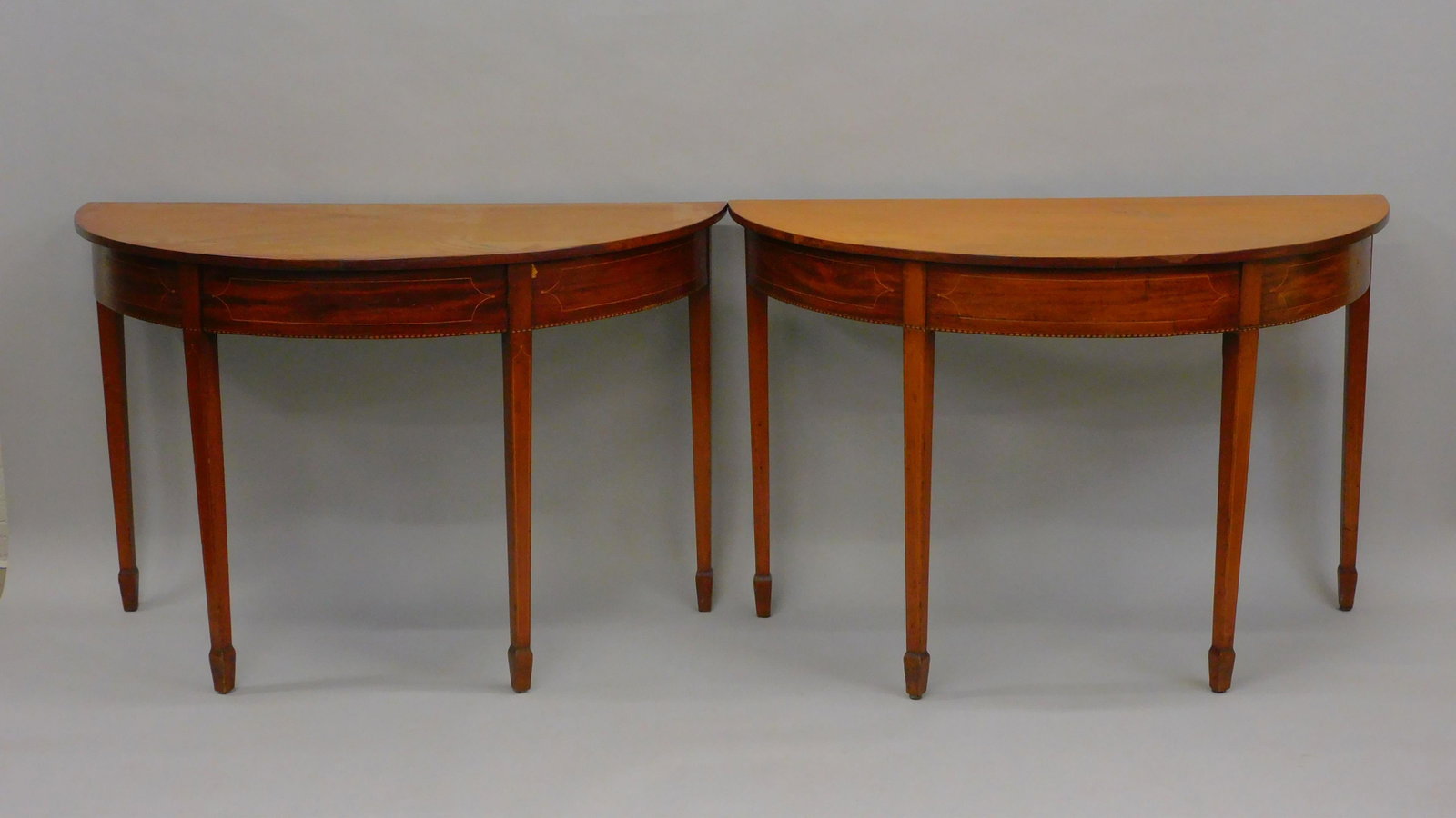(3) part banquet table. 19th century. Mahogany: with line inlay. Spayed foot. Old finish. 30" high, 45 3/4" wide, 107" long. Center section with swing legs. Age appropriate wear. Shows some repairs. Some legs rebraced. Hepplewhite style. No u-shape