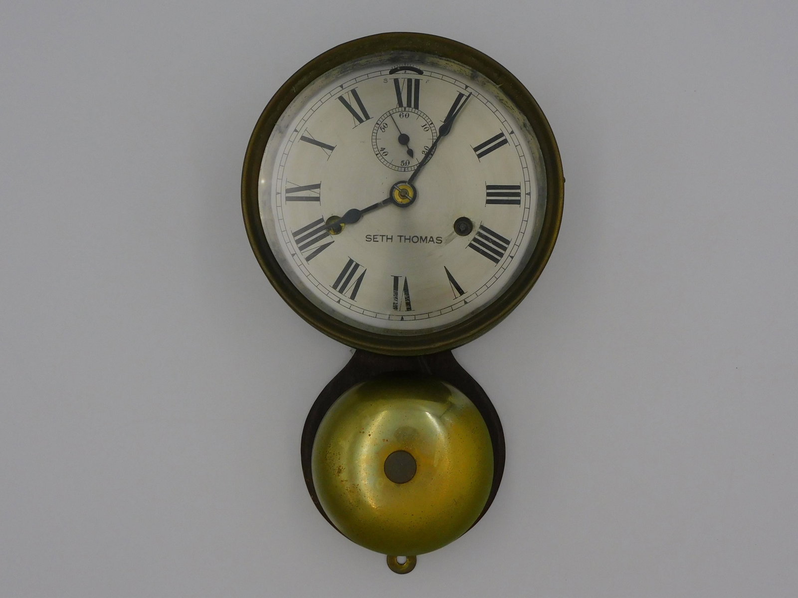 Seth Thomas ship's bell clock. Late 19th century.: On the verso label that reads the chronometer. 10 1/2" x 6 1/4" x 3". Currently working but not guaranteed