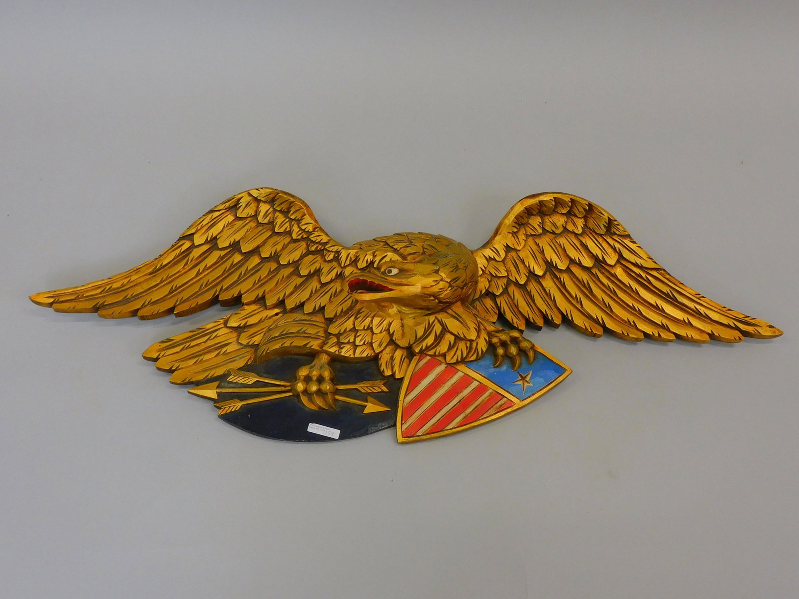 Bellamy Style Eagle. 20th century. A carved pine: gilt and painted American eagle in the style of John Haley . 16" x 43 3/4". Overall excellent condition.