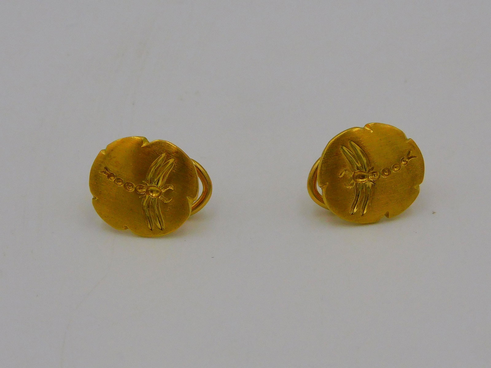 18kt Tiffany & Co. dragonfly fossil omega clip: earrings, 6. 4 dwt. Approx. 1/2" diameter. Comes with Tiffany blue bag. Please note: This lot must be paid for by wire transfer or cash. Items will be shipped or sent to shipper once payment clears.