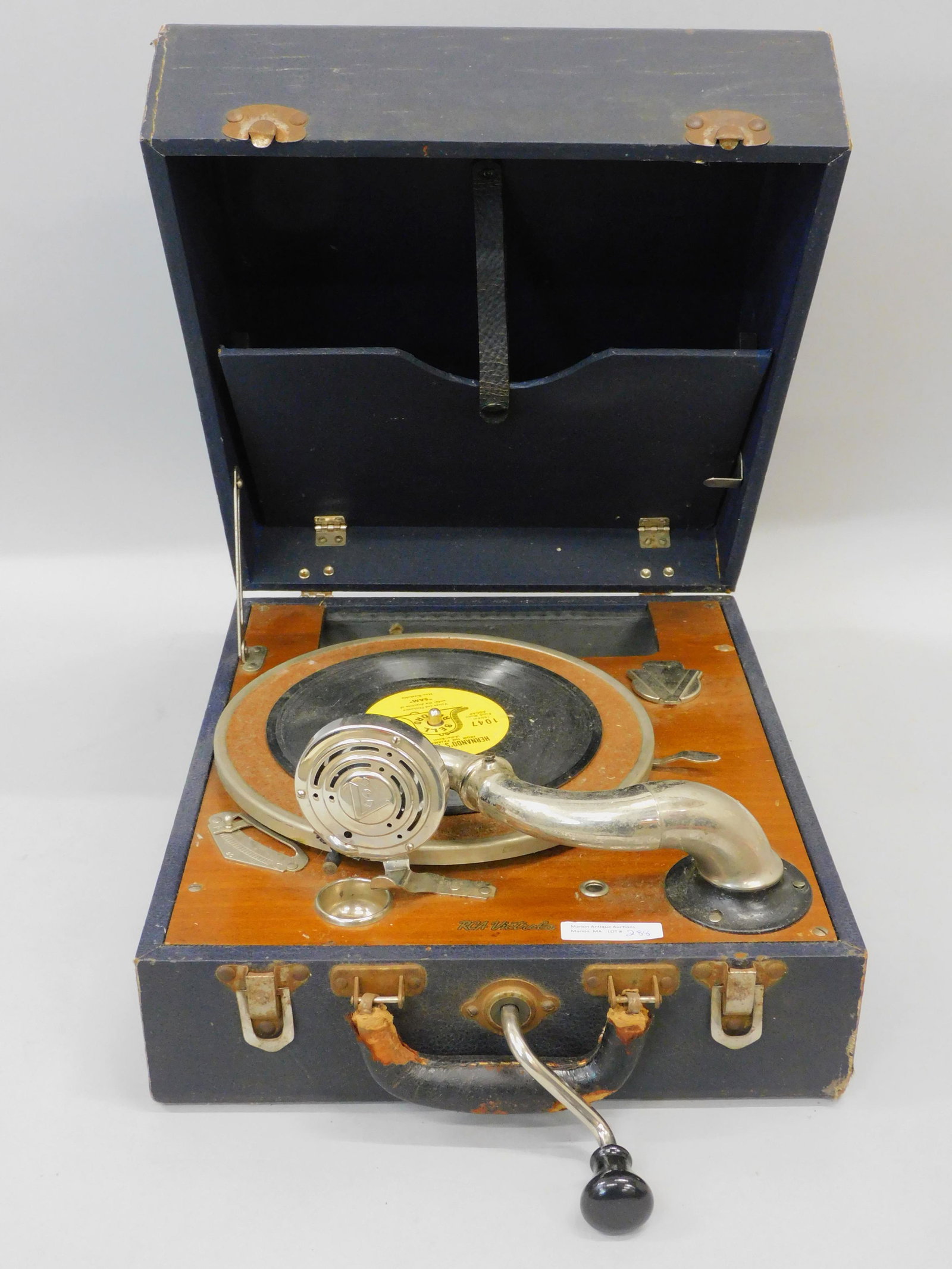 RCA Victor wind-up picnic-style Victrola or: record player. Leatherette finish traveling case. Original crank. Reproducer head is loose and needs adjusting. 7" high x 12 1/2" wide x 14 3/4" deep with 3" inch crank.