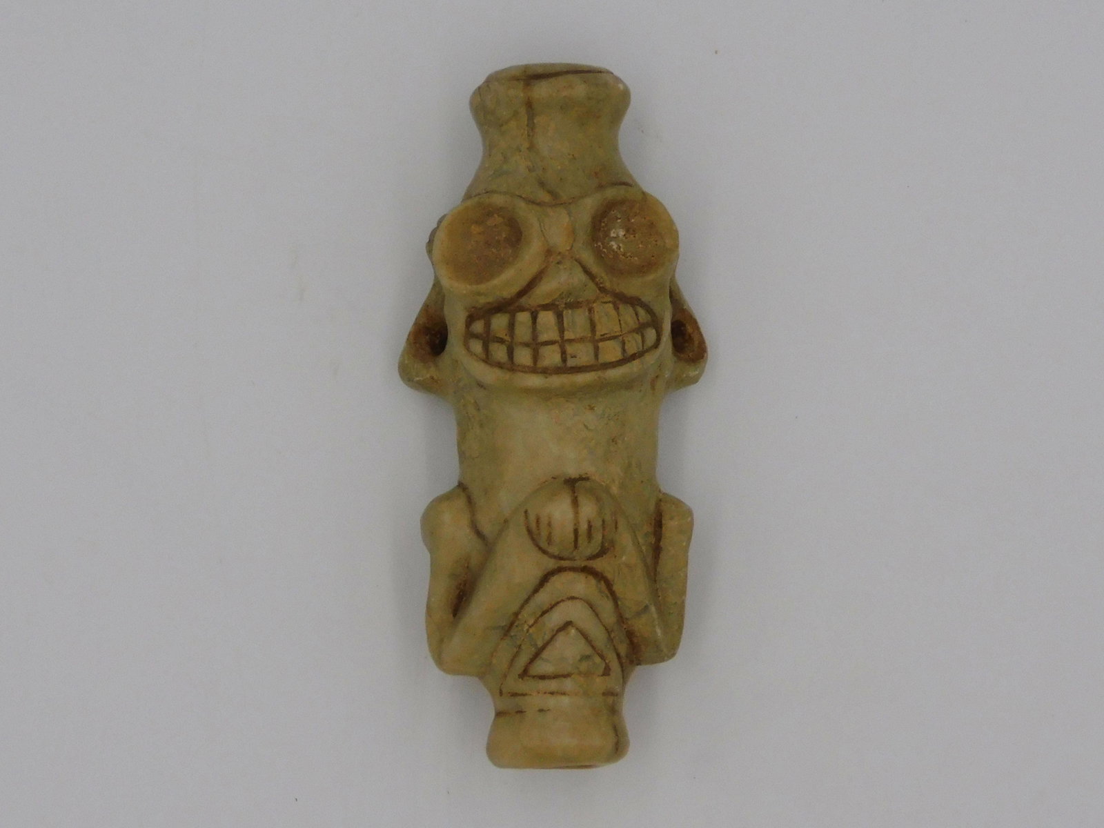 Taino cohoba inhaler. Circa 800â€“1500 AD. Ornate: fully formed anthropic cohoba or yopo inhaler. Type three. Beautifully rendered eyes and a smiling mouth with a full set of teeth. The top port has been flared to better fit the nose. Made of Jasper. 