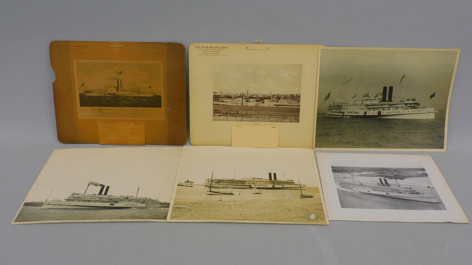 Collection of 2 calendars and 4 photographs: related to the Fall River Line. To include: a 1930 advertising calendar depicting the Bradford Durfee Steam Paddle Wheeler, and the Canonicus paddle wheel steamer, for the Fall River national bank. A 