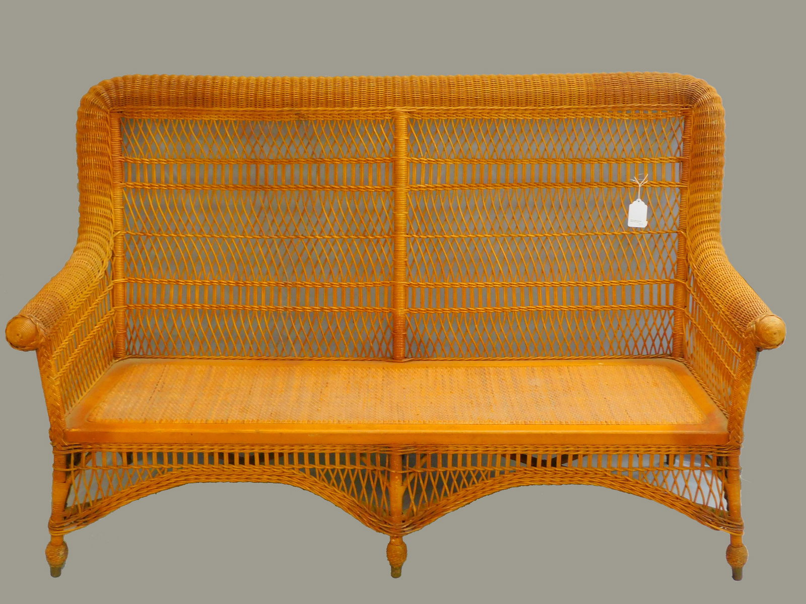 Rare wicker rolled arm sofa. Circa 1890. Heywood: Brothers & Company. Original natural finish. Excellent overall condition. Pre-modern seat cushions. 42" h, 66 1/2" wide, and 22" deep. Mary Jean McLaughlin collection.