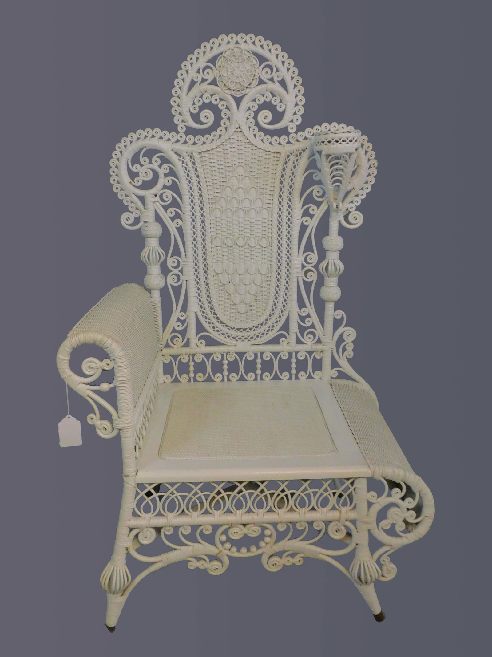 Rare Victorian wicker photographer's bench. Circa: 1890. Used in late 19th c primarily in photographer's studios as a posing chair. Newer white paint. Overall good condition. 55" high, 28" wide, and 21" deep. Mary Jean McLaughlin collection.