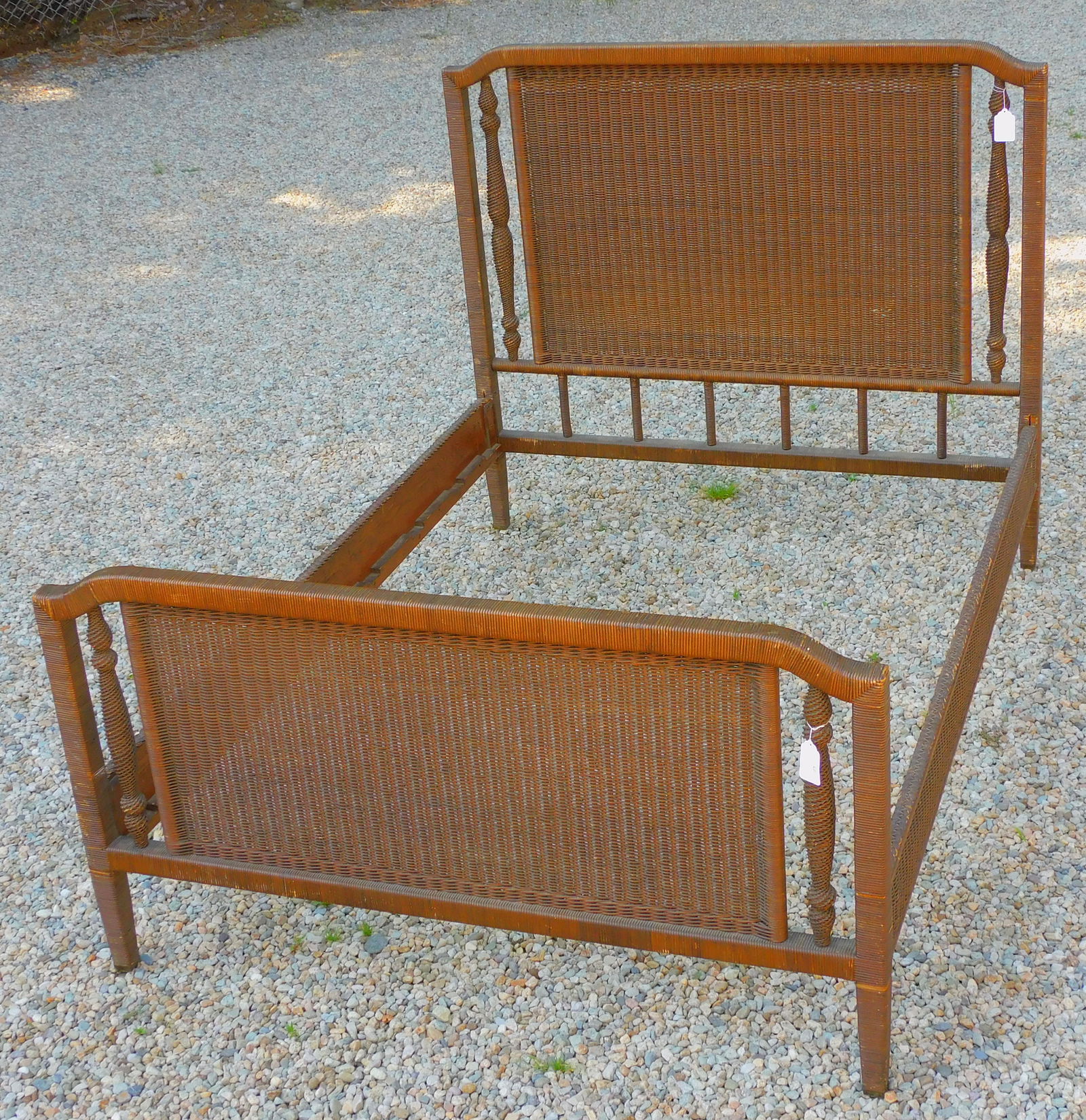 Art Deco wicker bed. Circa 1920. Double sized,: 54" wide. Original natural finish. Headboard, footboard and rails. Headboard measures 51" high x 56" wide. Some cane loss and unraveling on post. Some scuffing to finish. Footboard is 33" high and sho