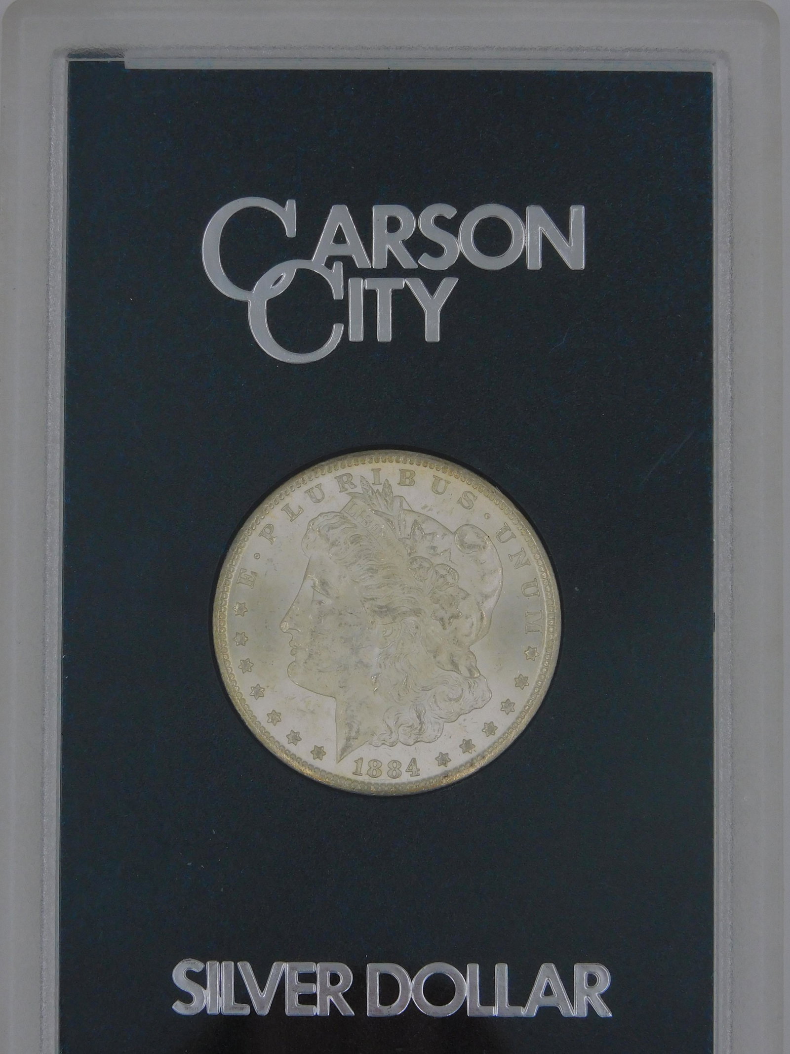 1884 CC silver dollar, uncirculated condition. In (1 of 3)