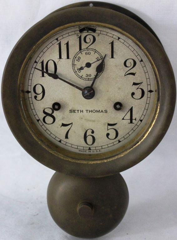 EARLY 20TH CENTURY BRASS WALL MOUNTED: SHIP’S CLOCK BY SETH THOMAS WITH ALARM BELL, 7” X 10”, KEY MISSING