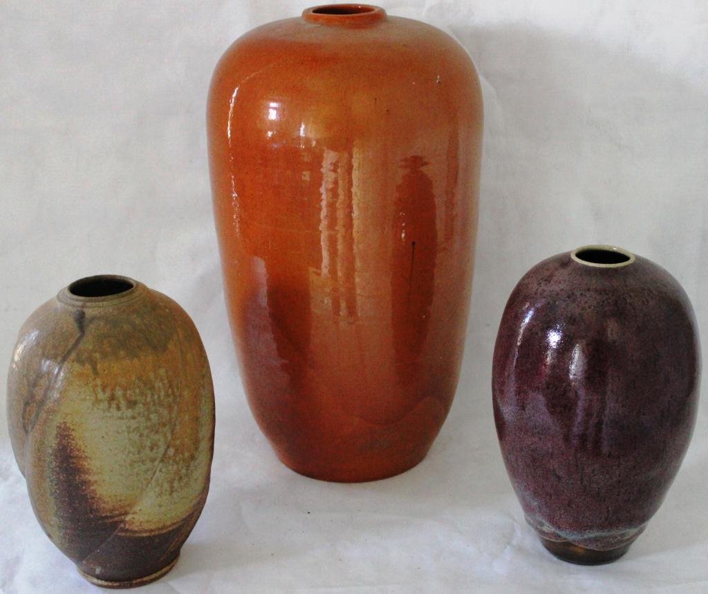 3 PIECE BEN OWEN JUGTOWN POTTERY LOT: CONSISTING OF RARE CRANBERRY COLOR, 9” HIGH VASE, A SWIRL FORM PUTTY 8 ¾” HIGH VASE AND A LAMP BASE, RED/ORANGE GLAZE 14 ½” HIGH