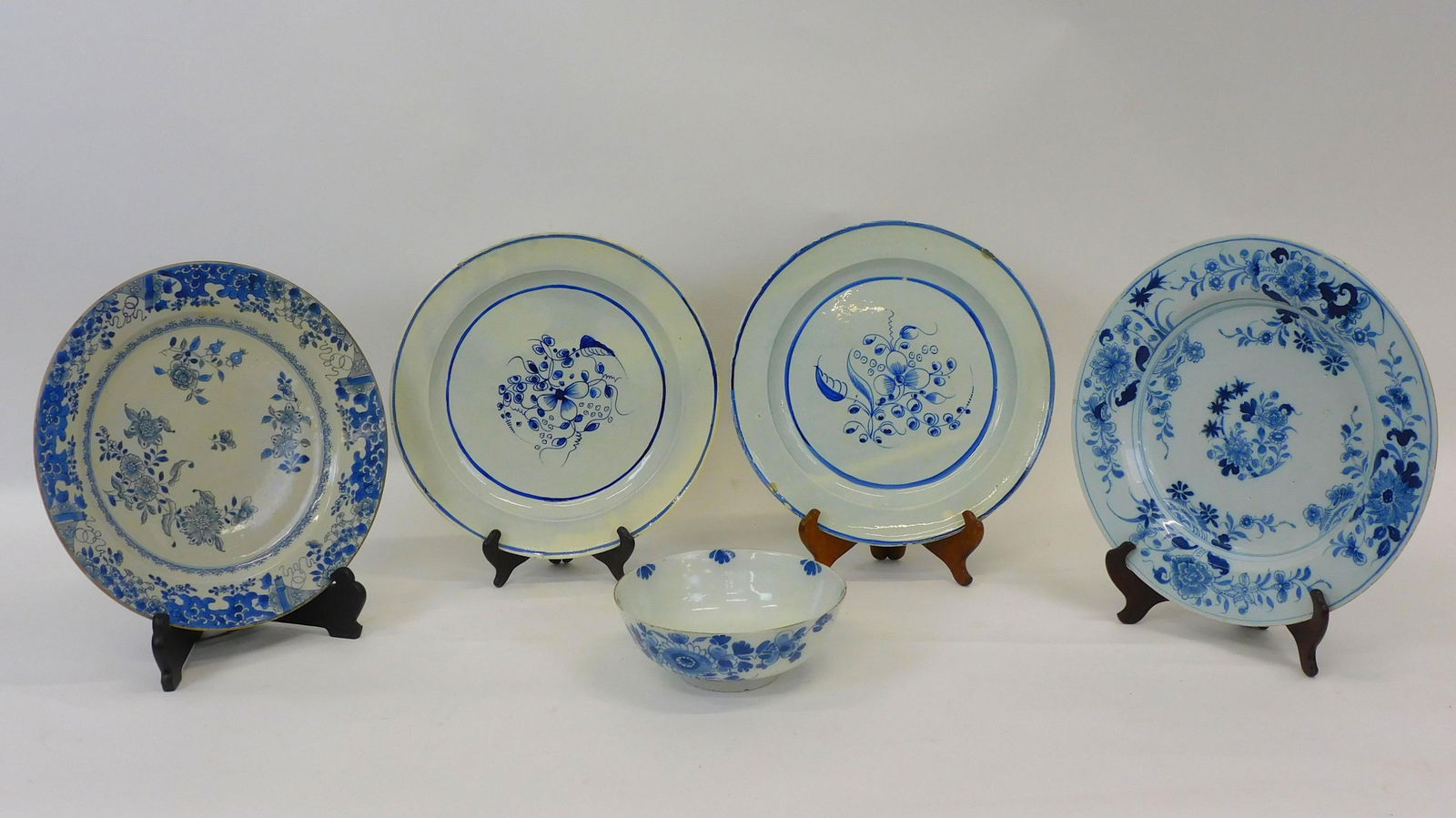 (5) pieces of tin-glazed earthenware or Delft.: 18th century. Four blue and white plates and a blue and white bowl. Two from the Gauthier collection. Plates measure range from 13 1/2" to 14 1/2" diameter. Bowl measures 8 1/2" diameter. Some show re