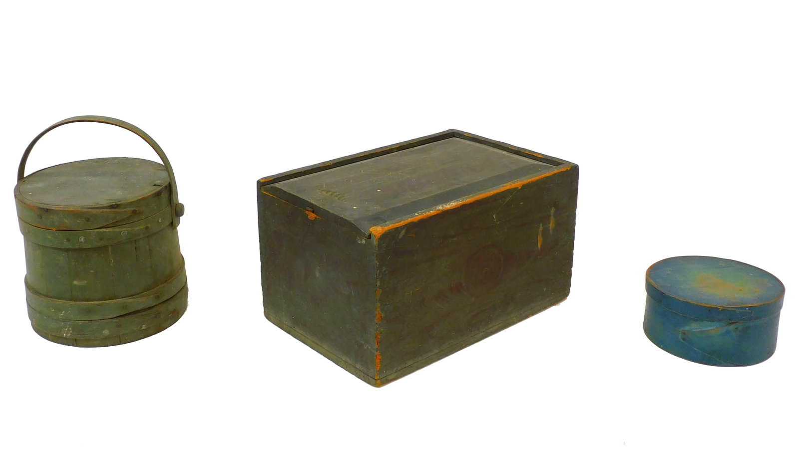 (3) pieces of wooden storage items. To include: a: round pantry box in blue paint, 4" high, 7 1/2" diameter. A dovetailed slide lid box in green-blue grain painted finish. 9 1/2" high, 11" wide, 16 1/2" deep. A swing handled firkin in greenish paint. 