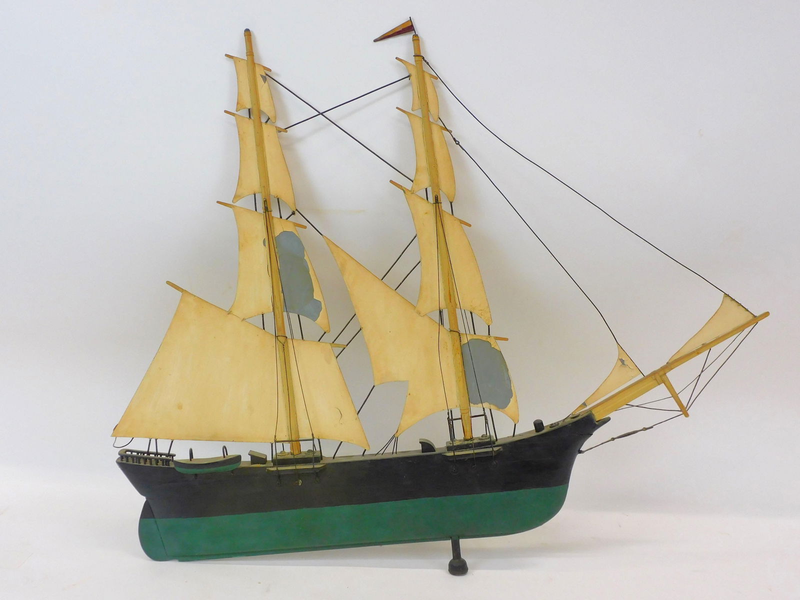 Martha's Vineyard Weathervane by Frank Adams.: Circa 1930s. A Frank Adams schooner weathervane with a wood hull and painted copper sails. 26" high by 32" wide. Some paint loss and slight separation of rigging. Comes with wall mount.