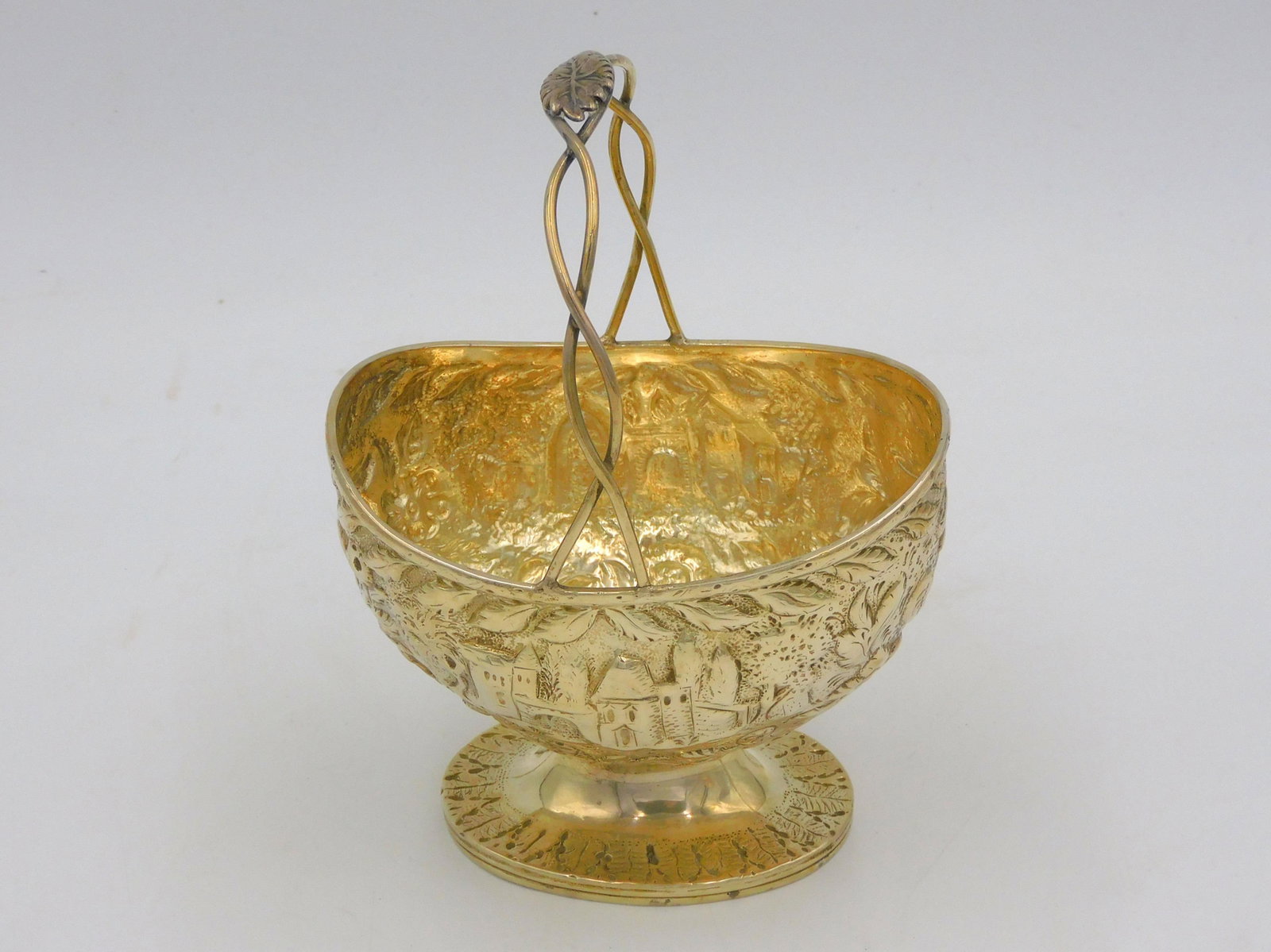 S. Kirk & Son Coin Silver Basket. 19th century.: Repousse castle and floral design. Entwining handle with leaf finial. 6 3/4" high by 4 3/4" wide. Very good condition. 6.7 ozt. Please note: this lot must be paid for by wire transfer or cash. Items w