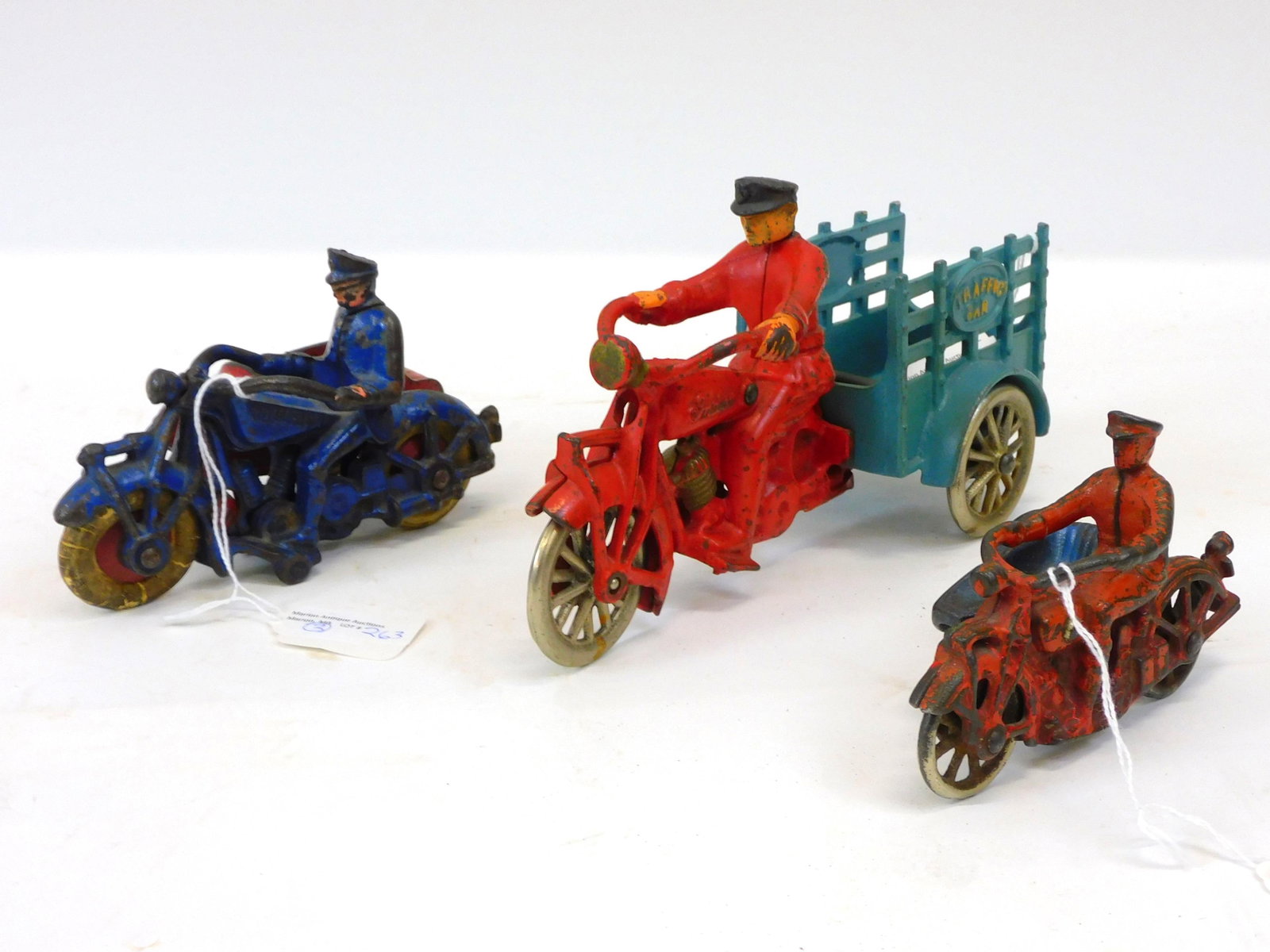 (3) cast iron motorcycles. Two with side car and: one with cart. All with drivers. Champion Hardware police motorcycle with side car and rubber wheels, 6" long. A Hubley police motorcycle with side car and metal wheels, 4 1/2" long. A Hubley motorcyc