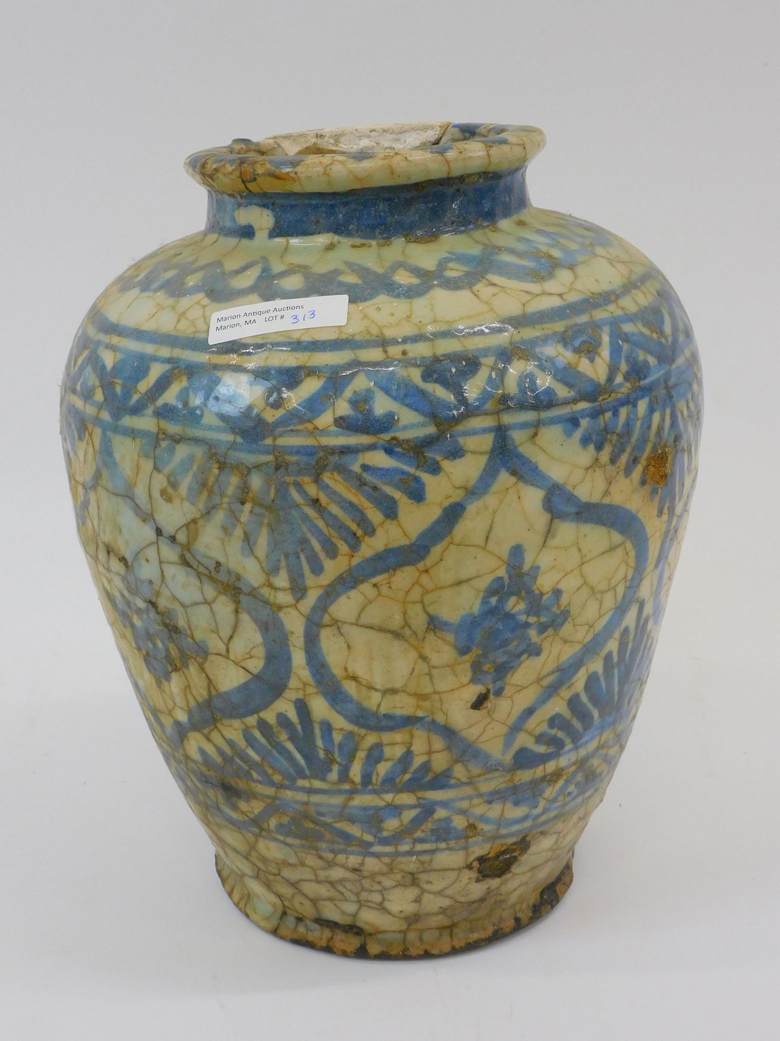 Islamic Mamluk Blue and White Jar. 16th century.: Made in Syria. Blue and white glazed stoneware with foliate design jar. 11 1/2" h. The jar shows cracks and repair to lip.