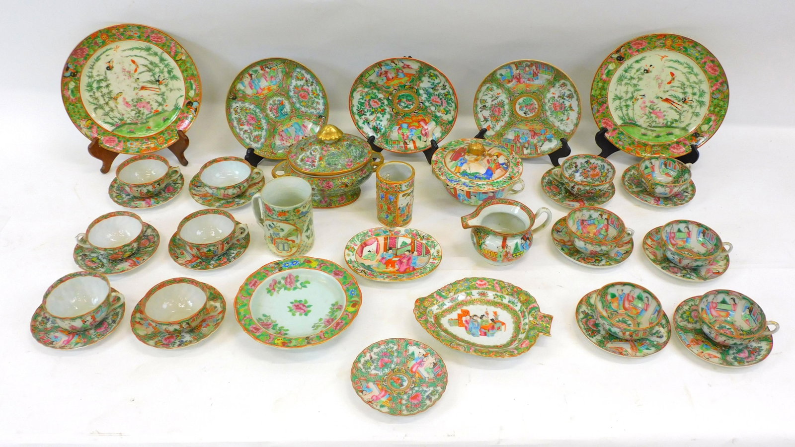 (38) piece Rose Medallion lot. 19th-century.: Chinese export porcelain. Includes small-covered tureen, 6" high x 8" wide. A strap handled mug, 4 1/2" high x 3 1/4" diameter. A leaf shaped plate, 8 1/4" wide x 6 1/4" deep. A pair 9 3/4" plates bot