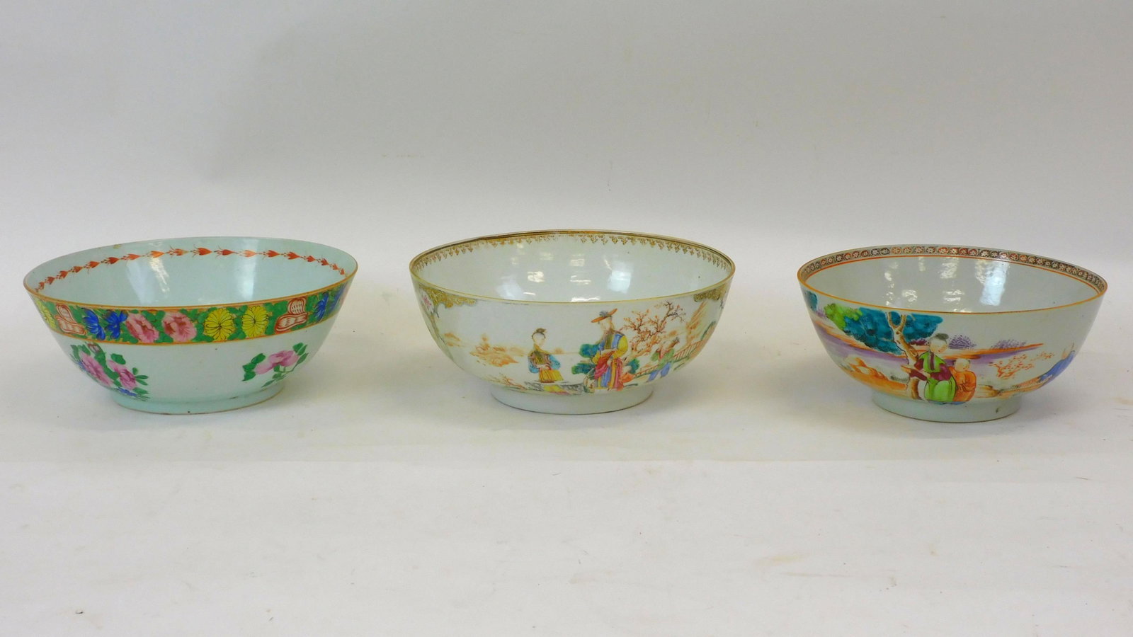 (3) Chinese export bowls. 19th-century. Two with: figures, one floral. The center bowl shows restoration. 4" to 4 1/4" high and 9" to 10" wide.