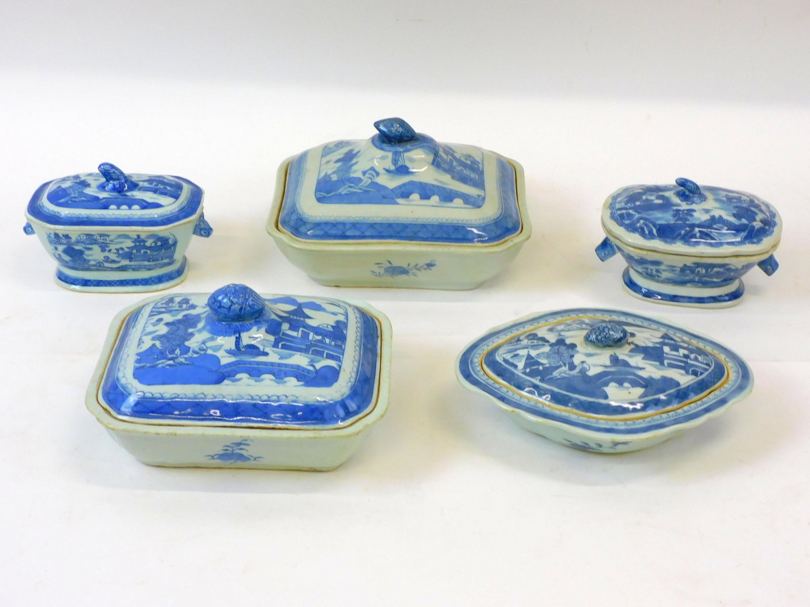 (5) Canton Chinese export covered dishes.: 19th-century. Blue and white porcelain with figural fruit finials. They range in height from 3" to 6" and in width from 6 1/2" to 9" wide. No visible damage.