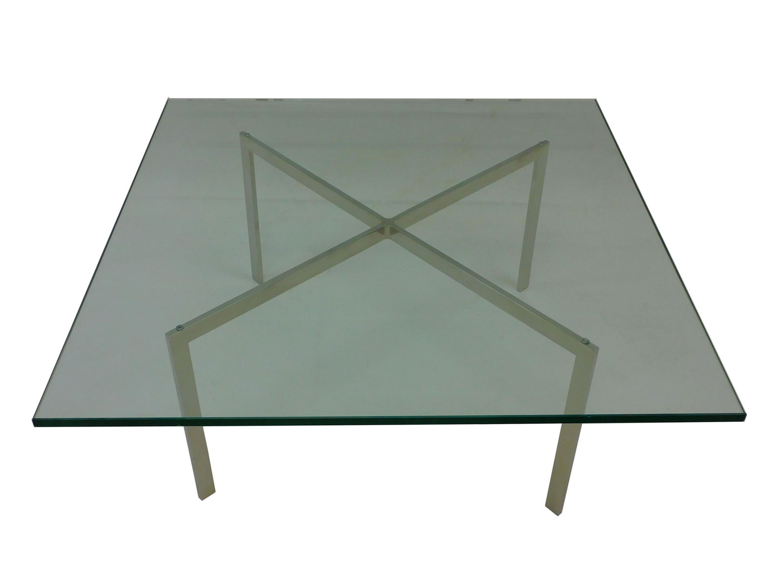 Ludwig Mies Van Der Rohe (1886-1969, Germany,: USA) for Knoll Barcelona Coffee Table. Signed solid stainless steel with Knoll factory marks KP. Impressed manufacturer's marked frame KP. Glass top. Very good condition. 17" high with top, 40" wide b