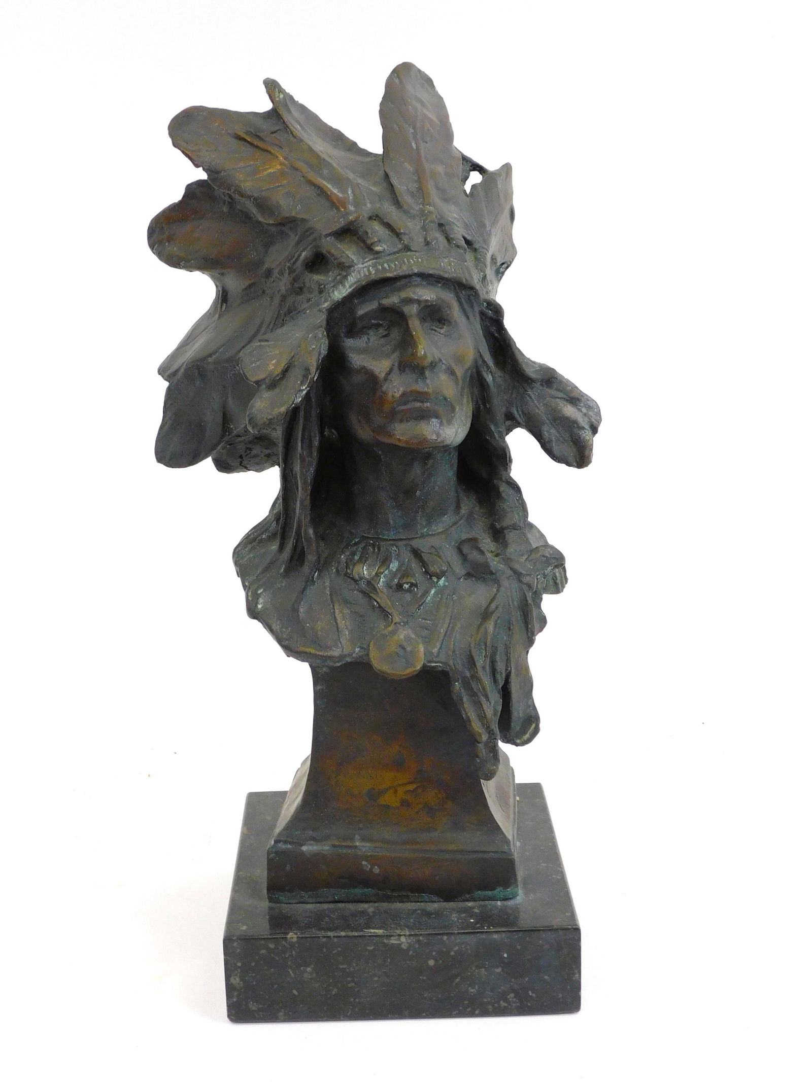After Charles Humphriss Bronze of Indian Chief.: 20th century. Native American Indian chief with headdress on a marble base. Later casting. Good condition with beautiful patina. Signed on side. Measures 11" high and 6" wide.