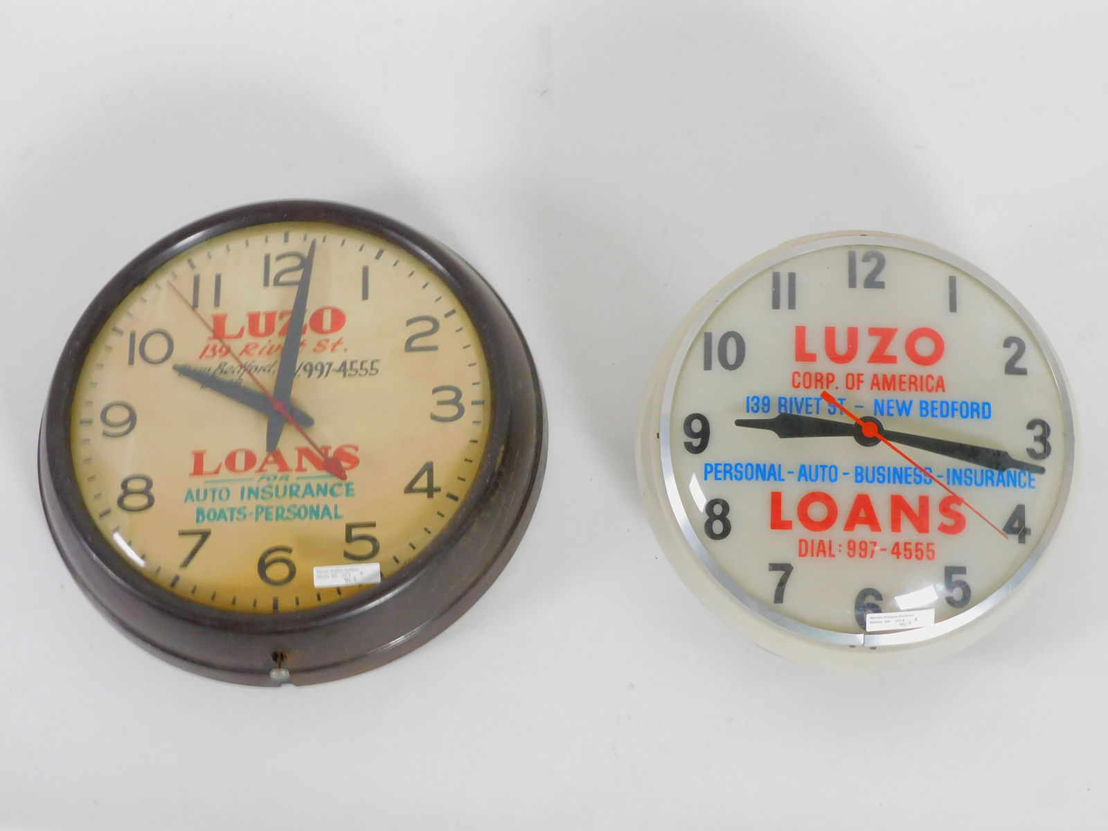 Two vintage advertising clocks for Luzo Loans and: Insurance in New Bedford. one is metal 14" diameter, 3" deep, working condition. The other is plastic 12" diameter, 3 3/4" deep. currently working condition.