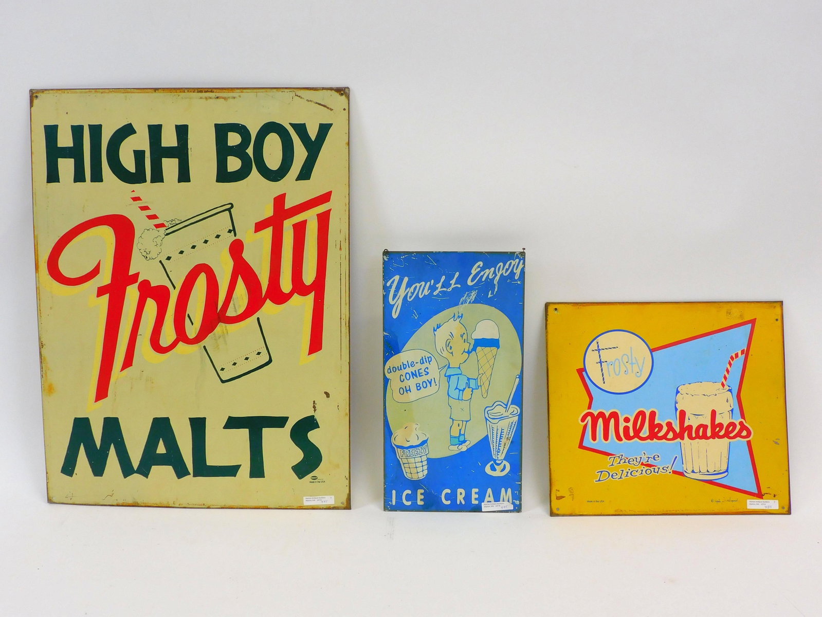 Three metal advertising signs to include high boy: frosty malts, 23 1/2" by 17 1/2", shows wear to the edges. Frosty milkshakes 12" by 13 1/2". Shows wear and rust on edges. Double dip ice cream cones, 15" by 8", shows wear to edges and scratches thro