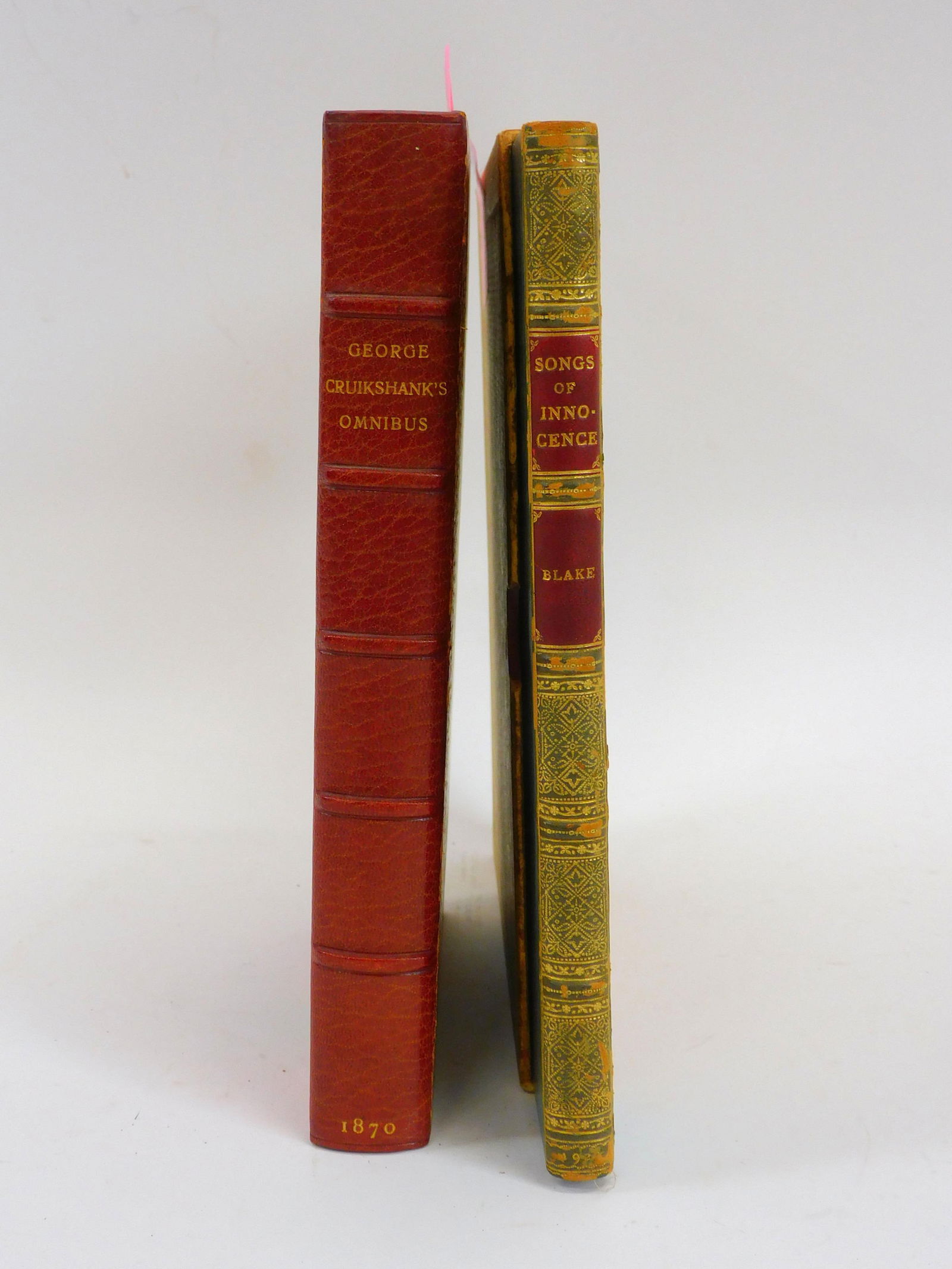 (2) volumes George Crucikshank's Ammibus 100: Engravings, London 1870. Bound in 1/2 red leather, all edges gilt, binding signed by Bayntun. About fine condition. Along with Songs of Innocence by William Blake and illustrated by Jacynth Parsons. P