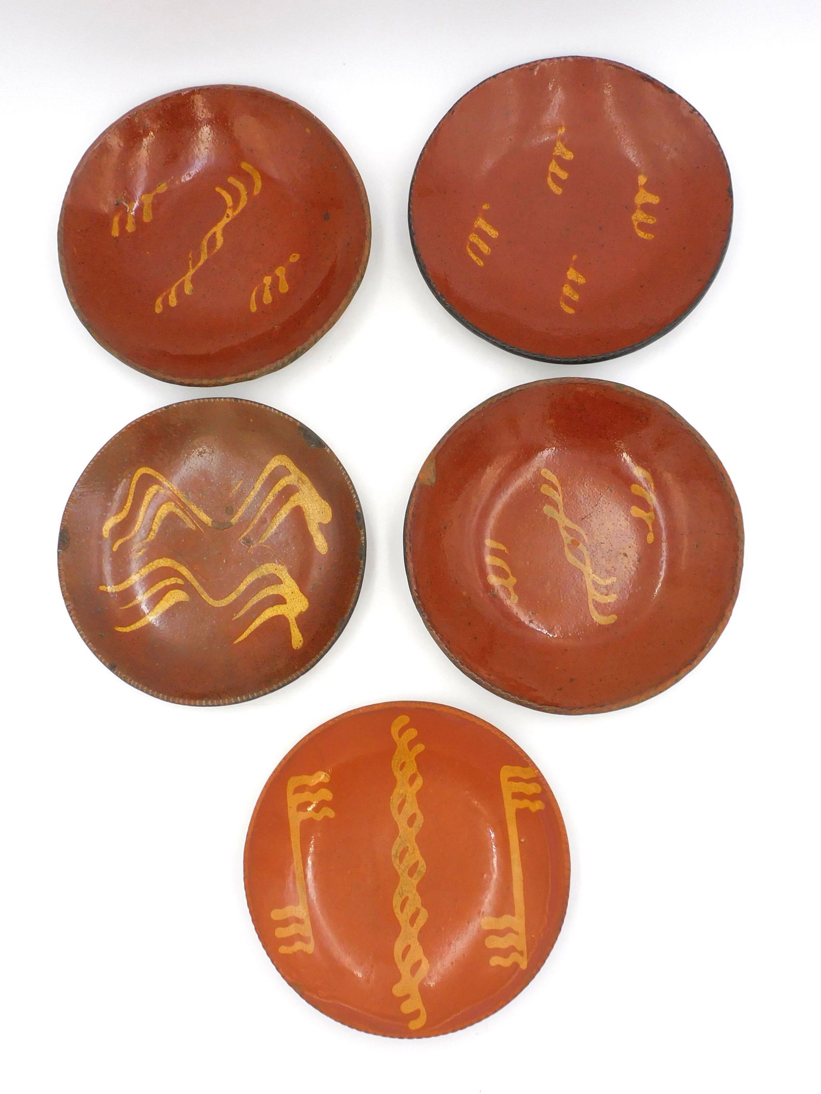 A collection of (5) redware yellow slip glazed bowls. (1 of 4)