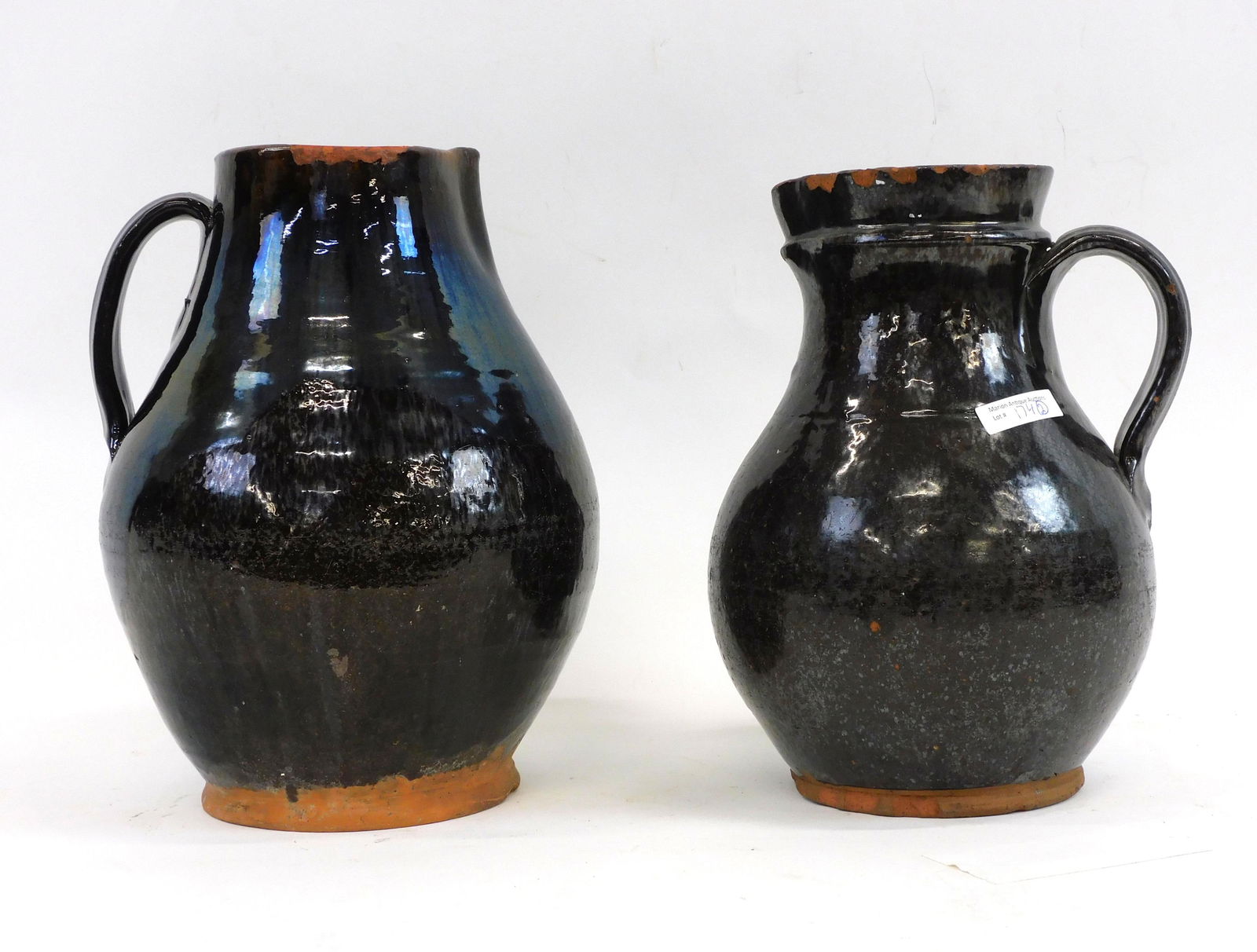 (2) redware handled pitchers. Early 19th century. (1 of 5)