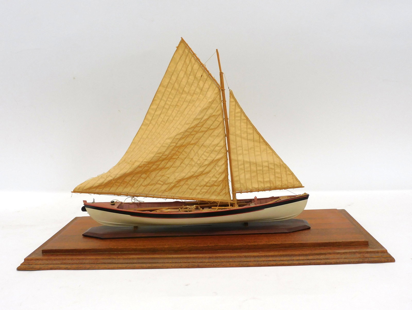 Cased Azorean whale boat model under sail with: complete rig. 20th century. Original painted finish, 15" high, 19" wide, 4" deep. Case size 17 3/4" high, 24 1/2" wide, 11 1/2" deep.
