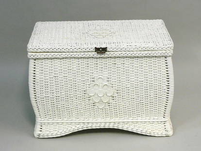 Wicker bedside storage chest with bombe front and: sides. Circa 1915. Brass hardware. 18" high, 25" wide, 15" deep. White painted finish. Good condition. Celluloid Heywood Wakefield Co. Provenance: Mary Jean McLaughlin estate.