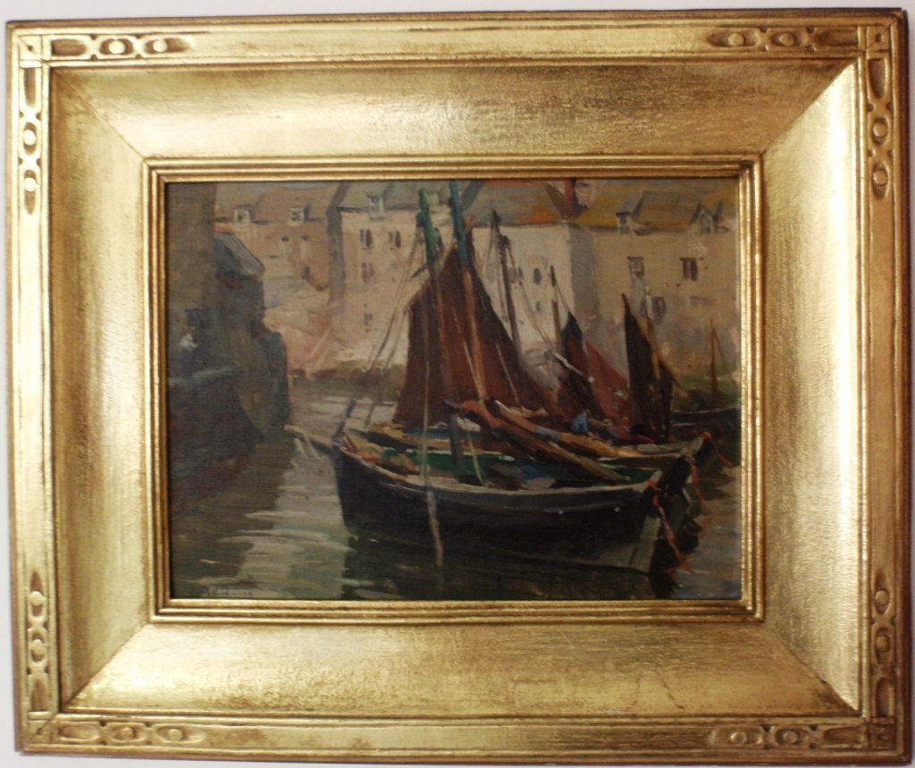 FRAMED OIL ON ARTIST BOARD BY MABEL MAY WOODWARD: (RHODE ISLAND, 1877-1945), 9" X 12 3/4", DEPICTING FISHING BOATS AT DOCK IN POLPERRO, A FISHING VILLAGE ON THE SOUTHEASTERN COAST OF CORNWALL, ENGLAND. IN EXCEPTIONAL ORIGINAL CARVED AND GILDED FRAME