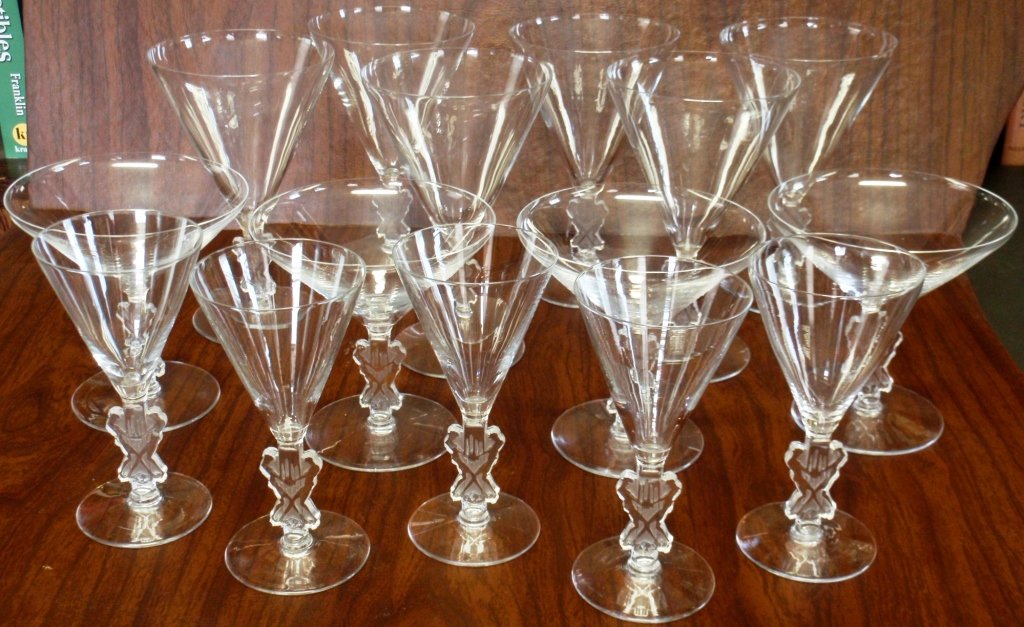 RARE 15 PCS. R. LALIQUE STEMWARE "STRASBOURG: BOURGOGNE" PATTERN (BASES DEPICT 2 MEN STOMPING ON GRAPES), CIRCA 1926, STENCILED R. LALIQUE ON THE BASES, CONSISTING OF 5 WINE GLASSES, 5" HIGH, 6 WATER GLASSES, 1 WITH SMALL CHIP TO RIM, 6 1/8" HIGH