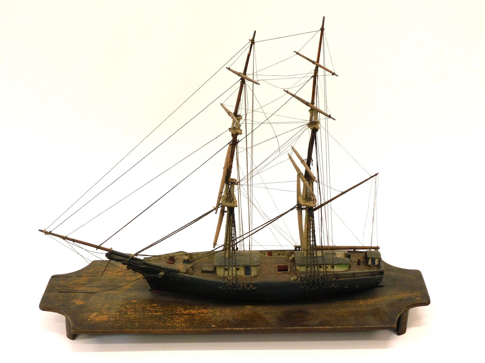Maine Coastal Brig Handmade Wooden Ship Model: Late 19th c. waterline cradle mount. 17 1/2" H x 20 1/4" L x 7 1/4" D. Original finish; overall good condition with some loose rigging lines.