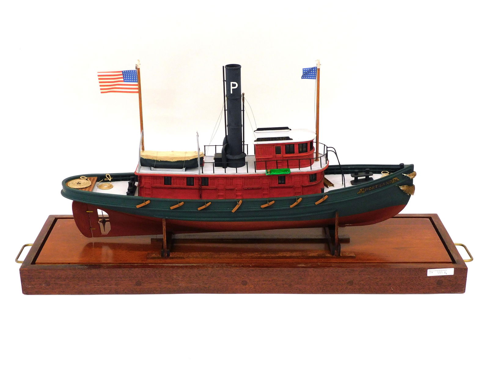 Cased Tug Boat Ship Model: Handmade by Dana McClean, Woolrich Maine. The model is of the tug Portland. Built in 1902, Central Wharf Tug Boat Company, Manager Joe E MacGowan. Comes with several copies of period photographs of th