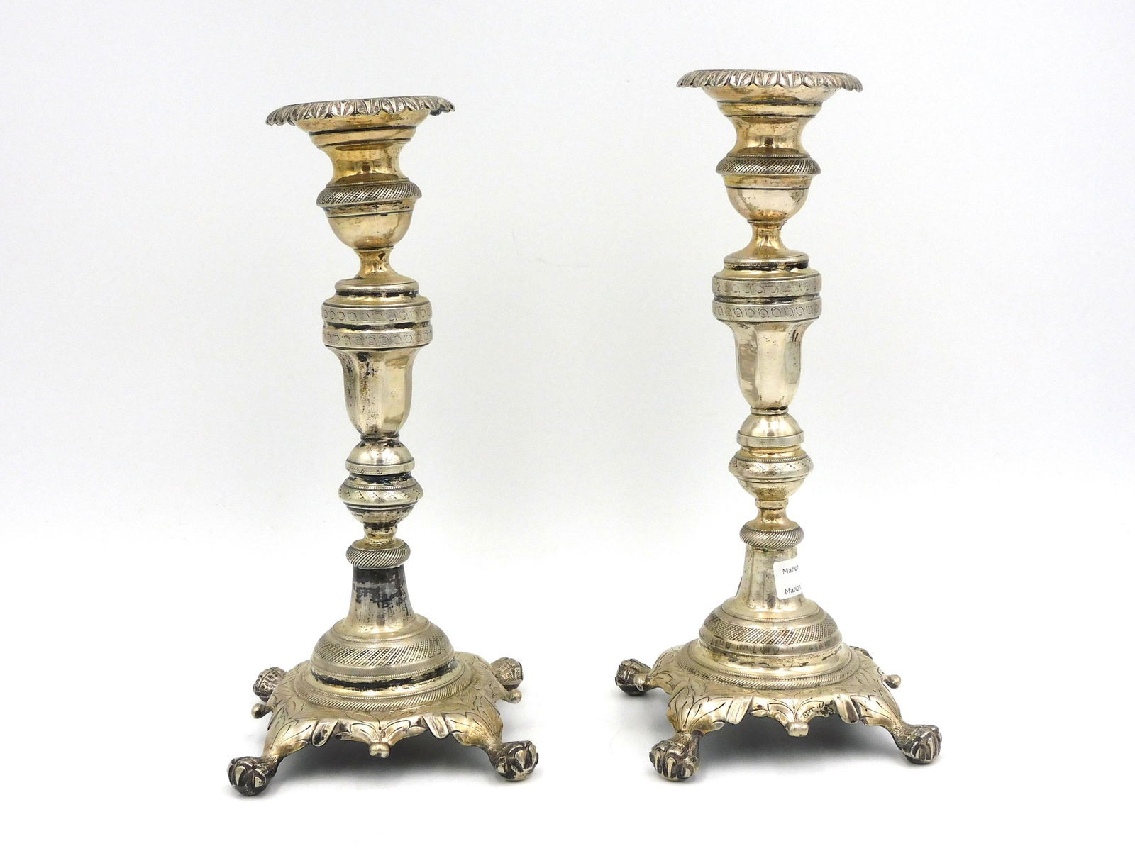 A Pair Of Spanish Colonial Silver Candlesticks: A baluster shaped shaft supported by claw feet. Illegibly marked. 9" high x 5" diameter at base. 23.12 ozt. Several very minor dents. Please note: this must be paid for by wire transfer, known check,