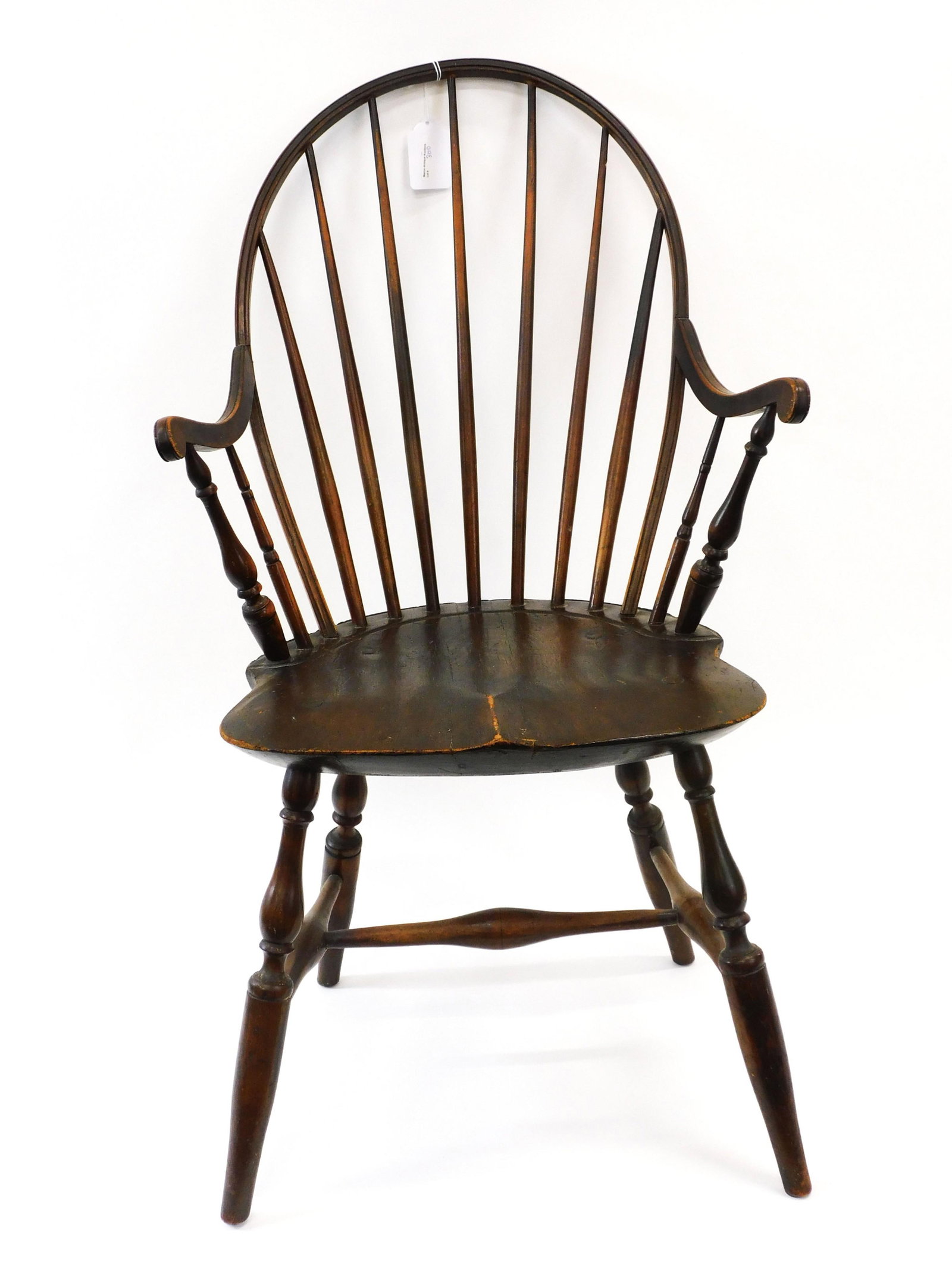 A New England Windsor Arm Chair: Possibly Rhode Island. 18th c. Old natural finish. Bold turnings. Saddle seat. 38 1/4" high x 21" wide x 18" deep. 17" seat height.