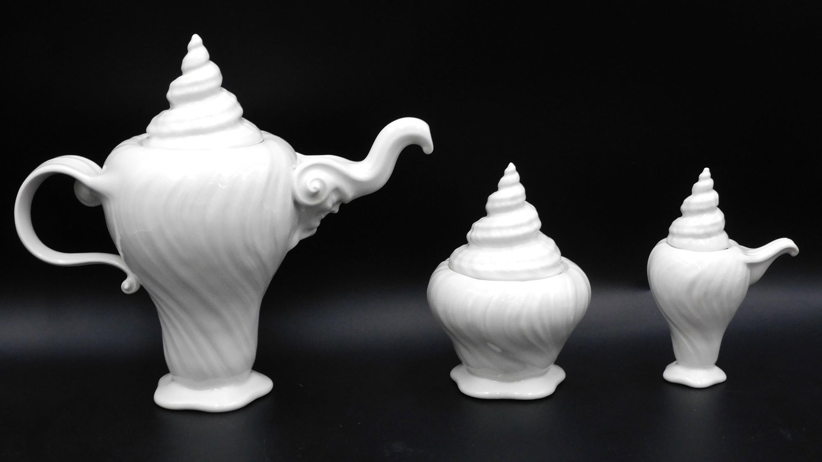 Royal Copenhagen (3-piece) Tea Set: Tritan pattern. Blanc-de-Chine finish. (3) pieces to include the teapot which is 9 3/4" high x 10 1/2" wide x 5" diameter. The creamer is 5 3/4" high x 4" wide. The sugar bowl is 6 1/4" high x 4" diam