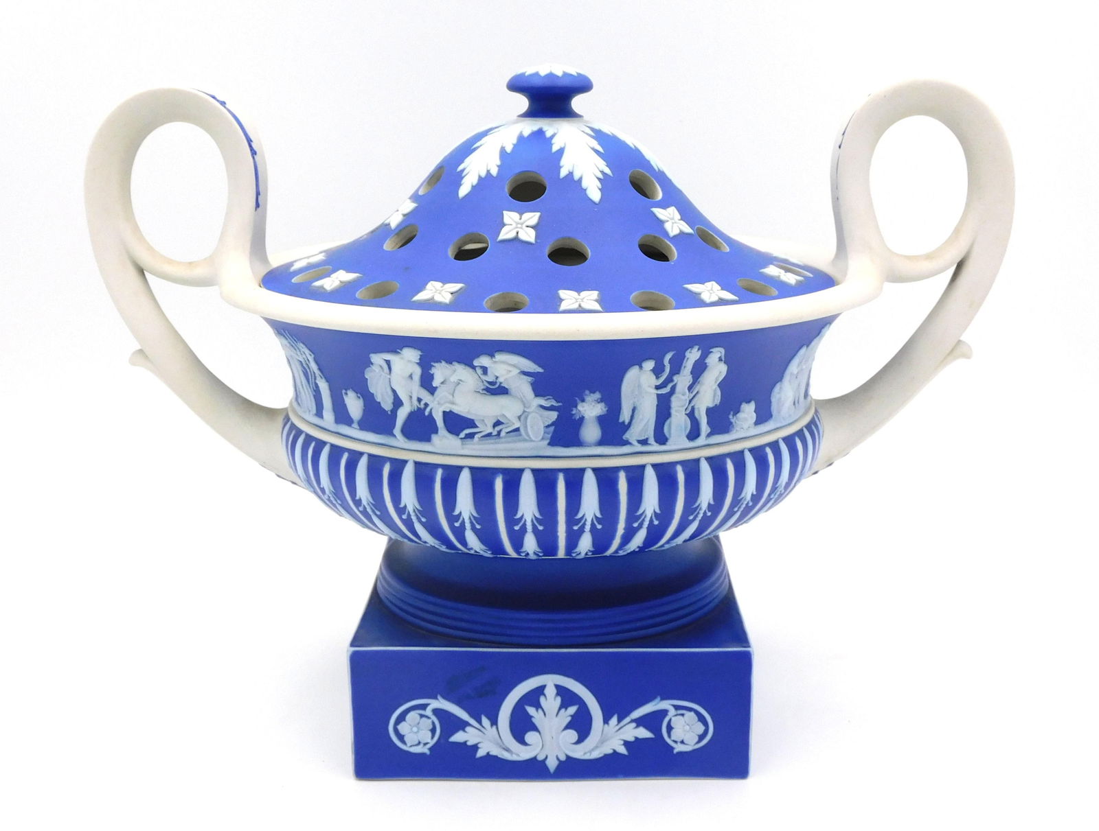 Wedgwood Jasperware Violeteer: 19th c. Urn form with square plinth base. Classical designs. Medium blue ground. 9 1/2" high x 13" wide x 9 1/2" diameter.